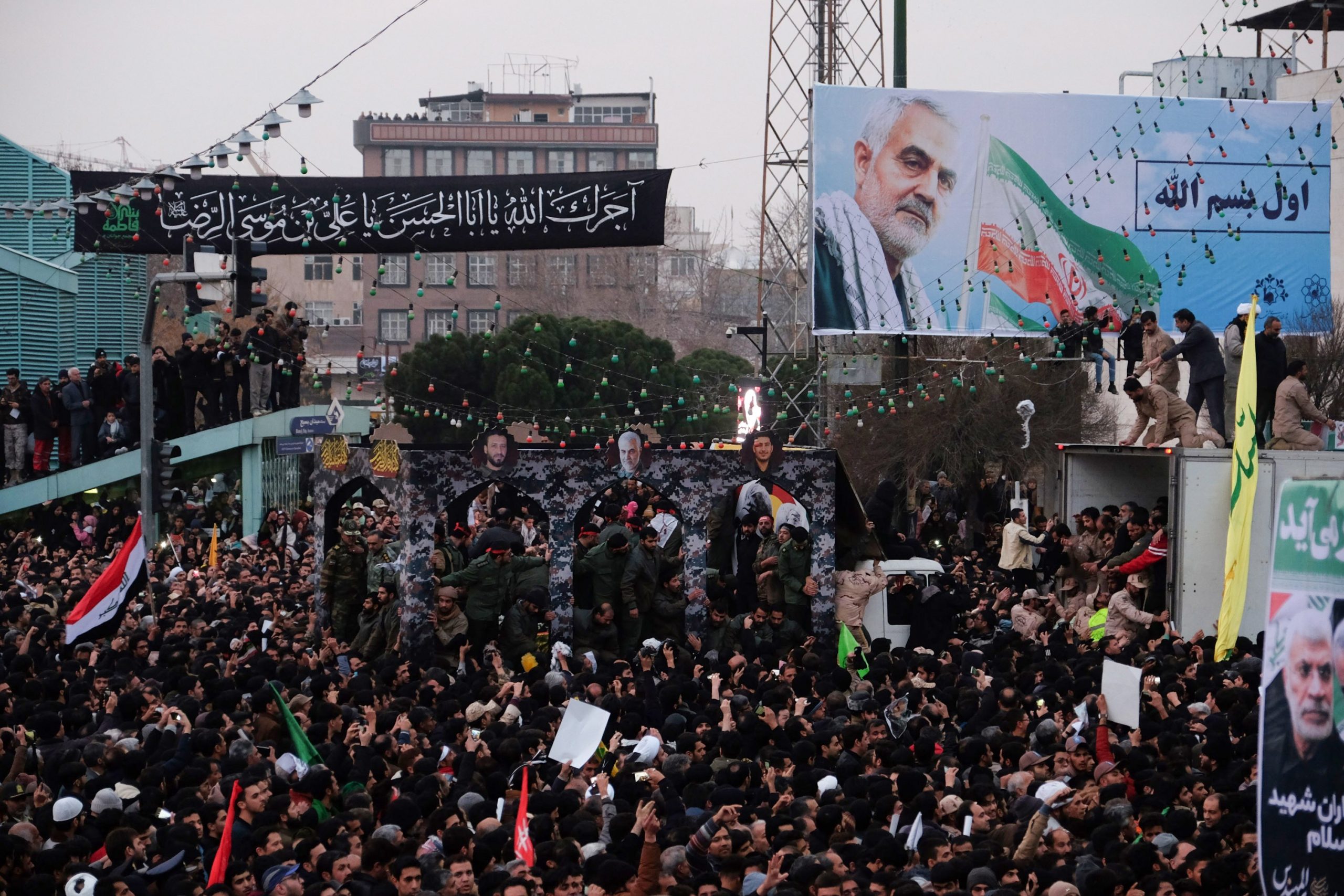 Iranians gather around a vehicle carrying the coffins of slain major general Qassem Soleimani and others, as they pay homage in the northeastern city of Mashhad on Jan. 5, 2020. (Credit: MEHDI JAHANGHIRI/IRAN'S FARS NEWS AGENCY/AFP via Getty Images)