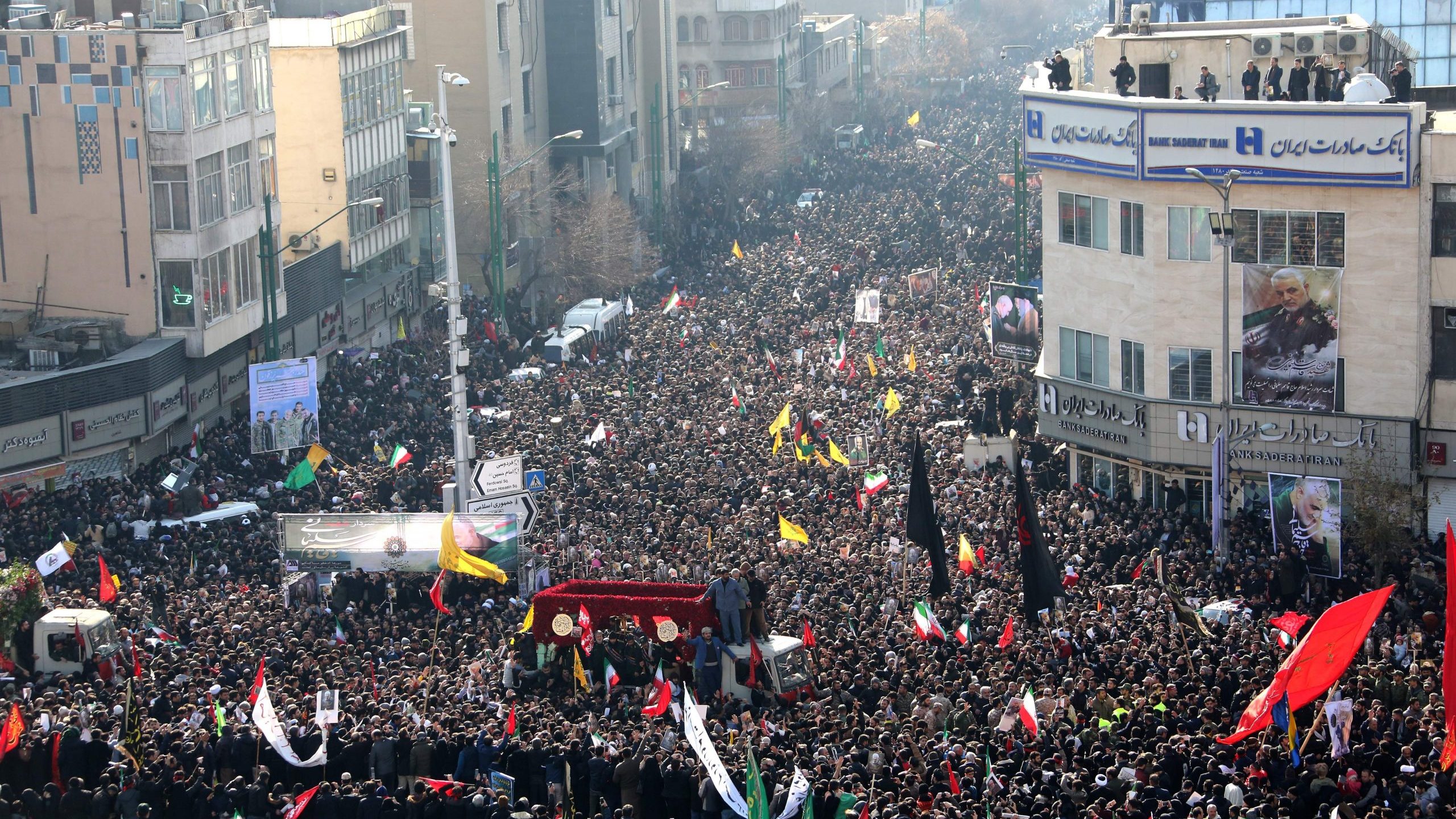 Iranian mourners take part in a funeral procession in the capital Tehran on January 6, 2020, for slain military commander Qasem Soleimani, Iraqi paramilitary chief Abu Mahdi al-Muhandis, and other victims of a US attack. (Credit: ATTA KENARE/AFP via Getty Images)