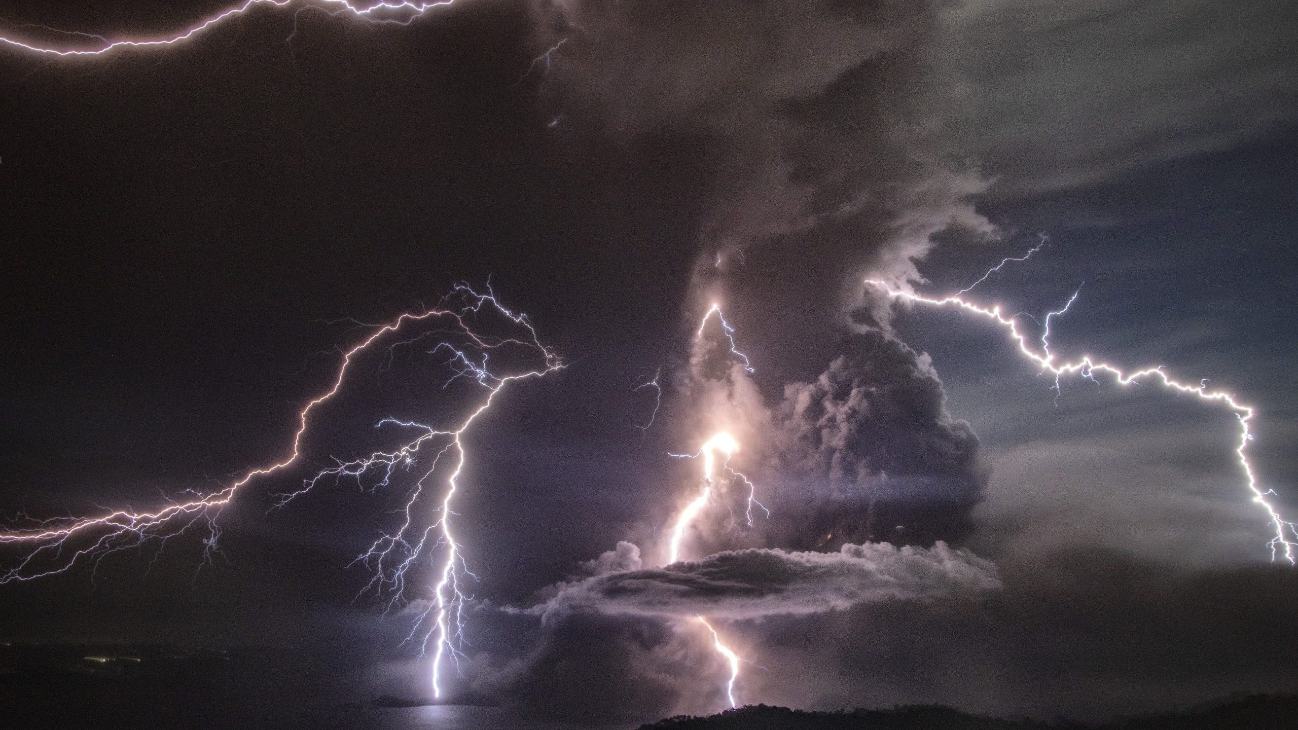 Lightning strikes as a column of ash surrounds the crater of Taal Volcano as it erupts on Jan. 12, 2020, as seen from Tagaytay city, Cavite province, Philippines. (Credit: Ezra Acayan/Getty Images)