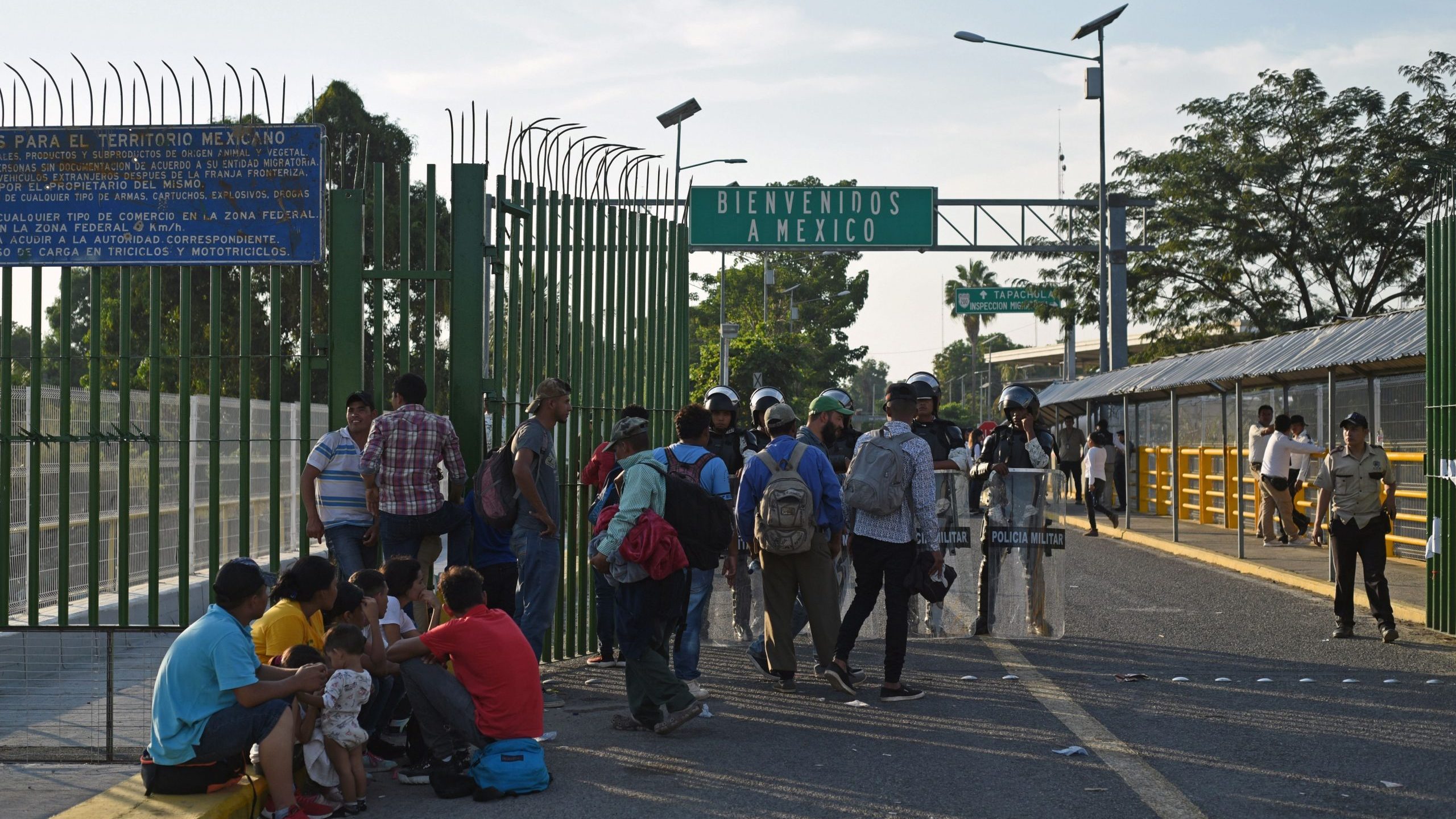 Honduran migrants wait to cross the international border bridge from Ciudad Tecun Uman in Guatemala to Ciudad Hidalgo in Mexico, on Jan. 18, 2020. (Credit: JOHAN ORDONEZ/AFP via Getty Images)