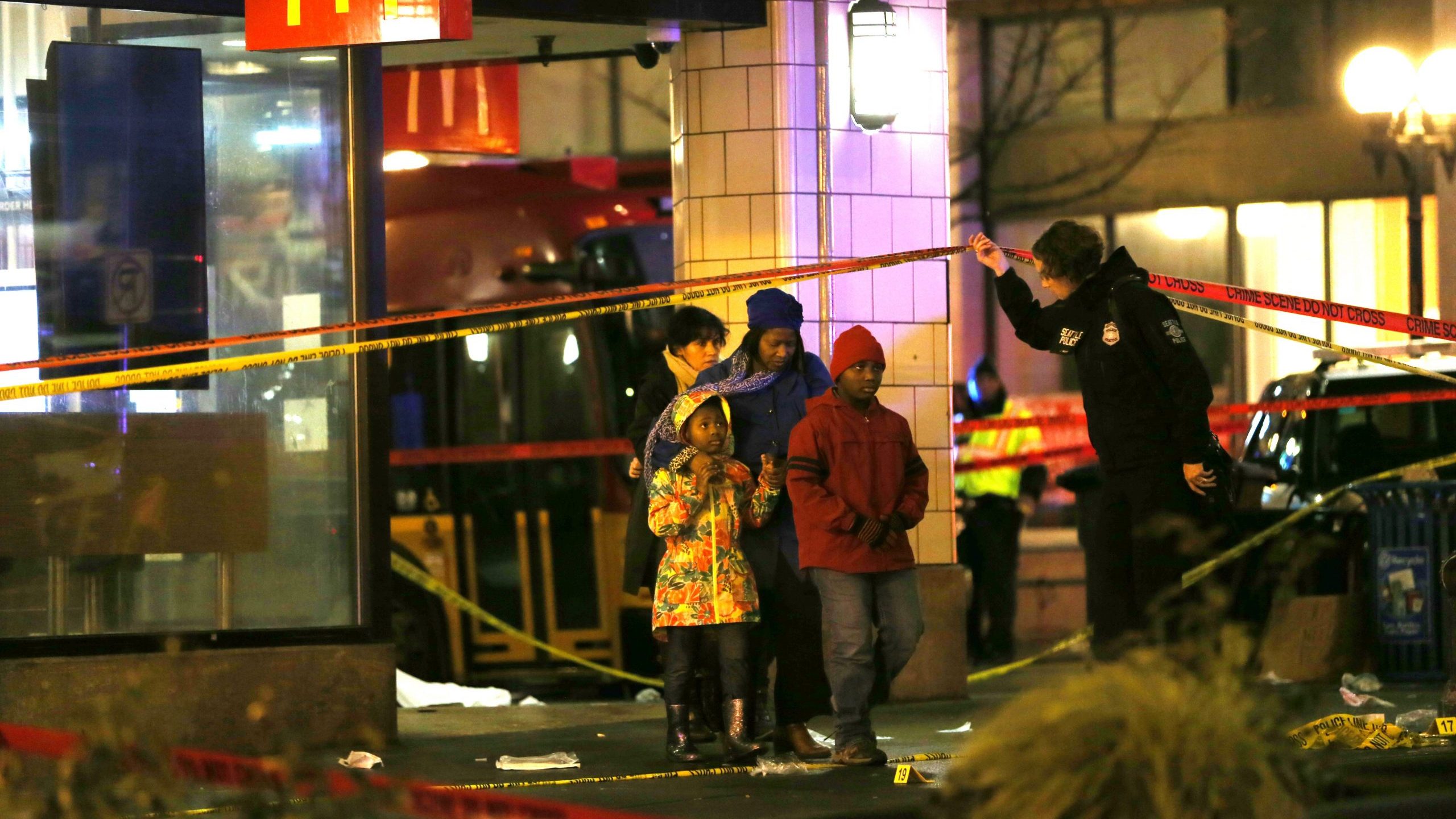 People are escorted by police away from the scene of a shooting in Seattle's central business district on Jan. 22, 2020. (Credit: Karen Ducey / Getty Images)