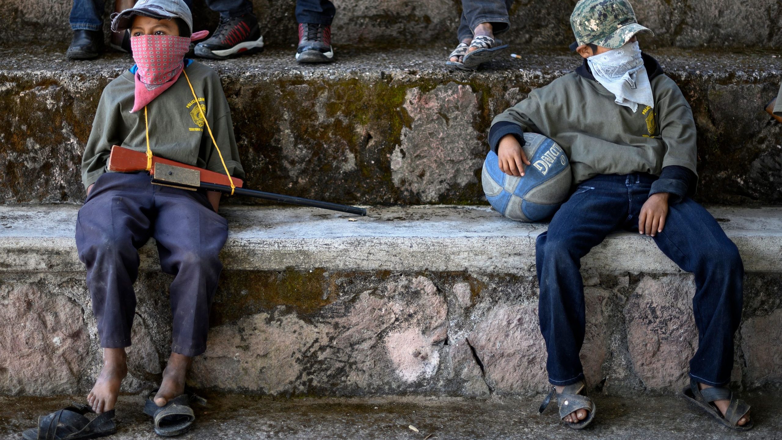 Children are tought to use weapons by the Regional Coordinator of Community Authorities (CRAC-PF) community police force at a basketball court in the village of Ayahualtempan, Guerrero State, Mexico, on Jan. 24, 2020. (Credit: PEDRO PARDO/AFP via Getty Images)