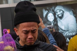 A man cries in front of a makeshift memorial for Kobe Bryant and his daughter Gianna in front of the Staples Center on Jan. 27, 2020. (Credit: Apu Gomes / AFP / Getty Images)