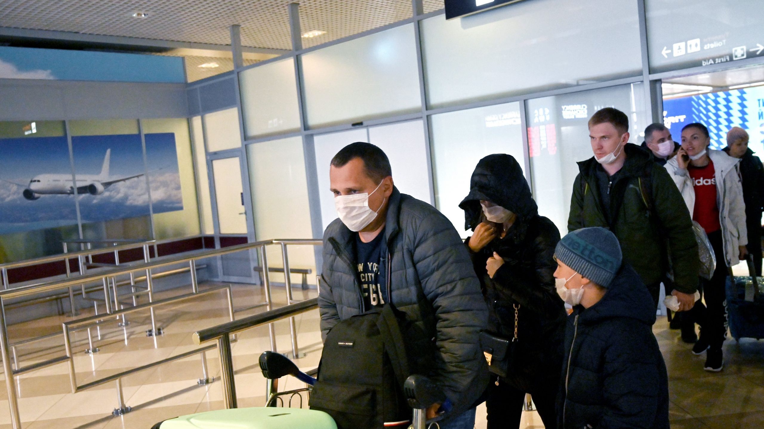 Ukrainian tourists walk in the arrival hall of the Internatioanal Boryspil airport outside Kiev after their plane landed from China on Jan. 30, 2020. The first out of four special flights will be held on Jan. 30, 2020, in order to evacuate hundreds of Ukrainian tourists from China as the deadly coronavirus outbreak grows. (Credit: SERGEI SUPINSKY/AFP via Getty Images)