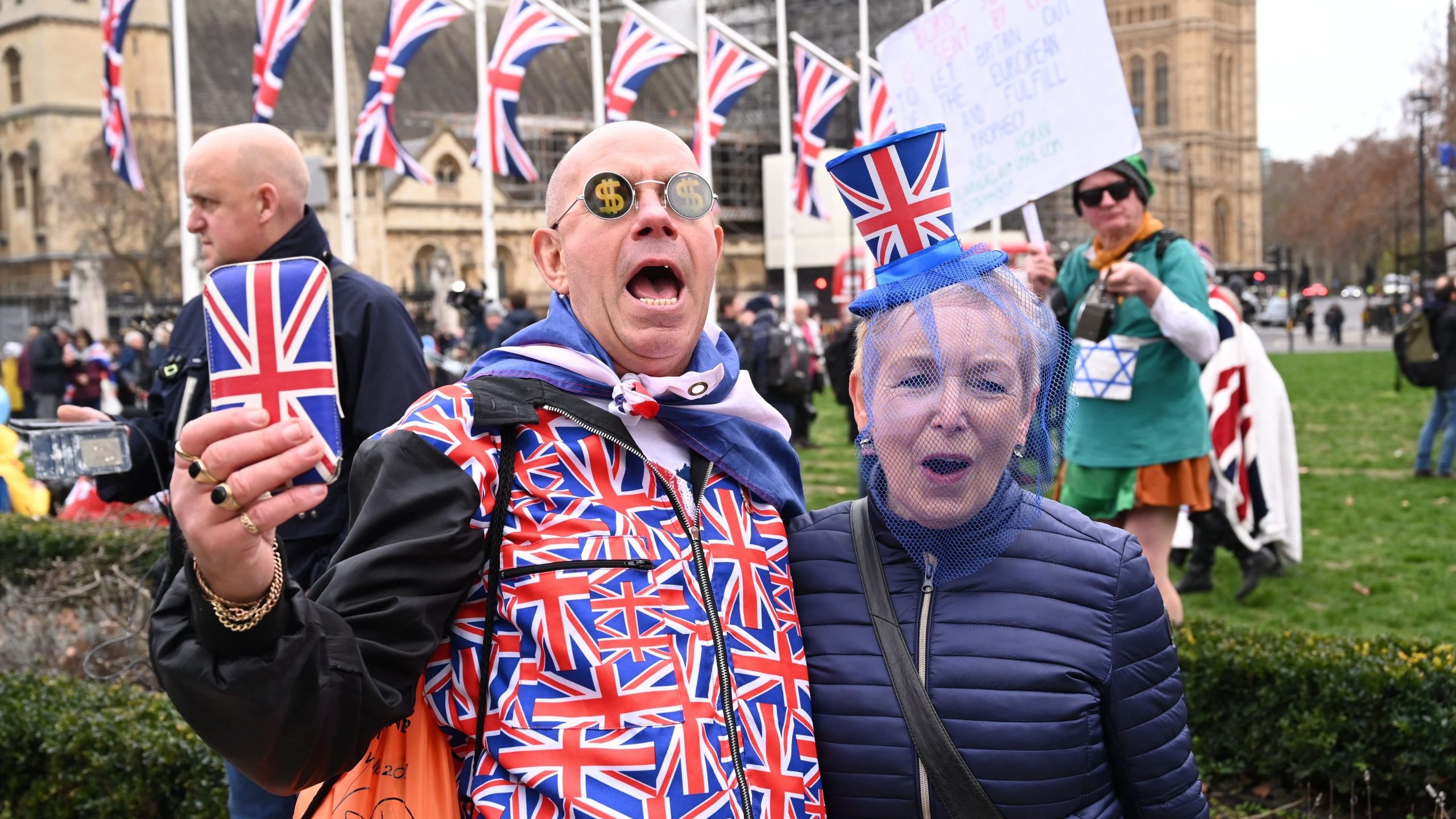 Brexit supporters wearing Union Flag-themed dress react in Parliament Square in London on Jan. 31, 2020, the day the U.K. formally leaves the European Union. (Credit: GLYN KIRK/AFP via Getty Images)