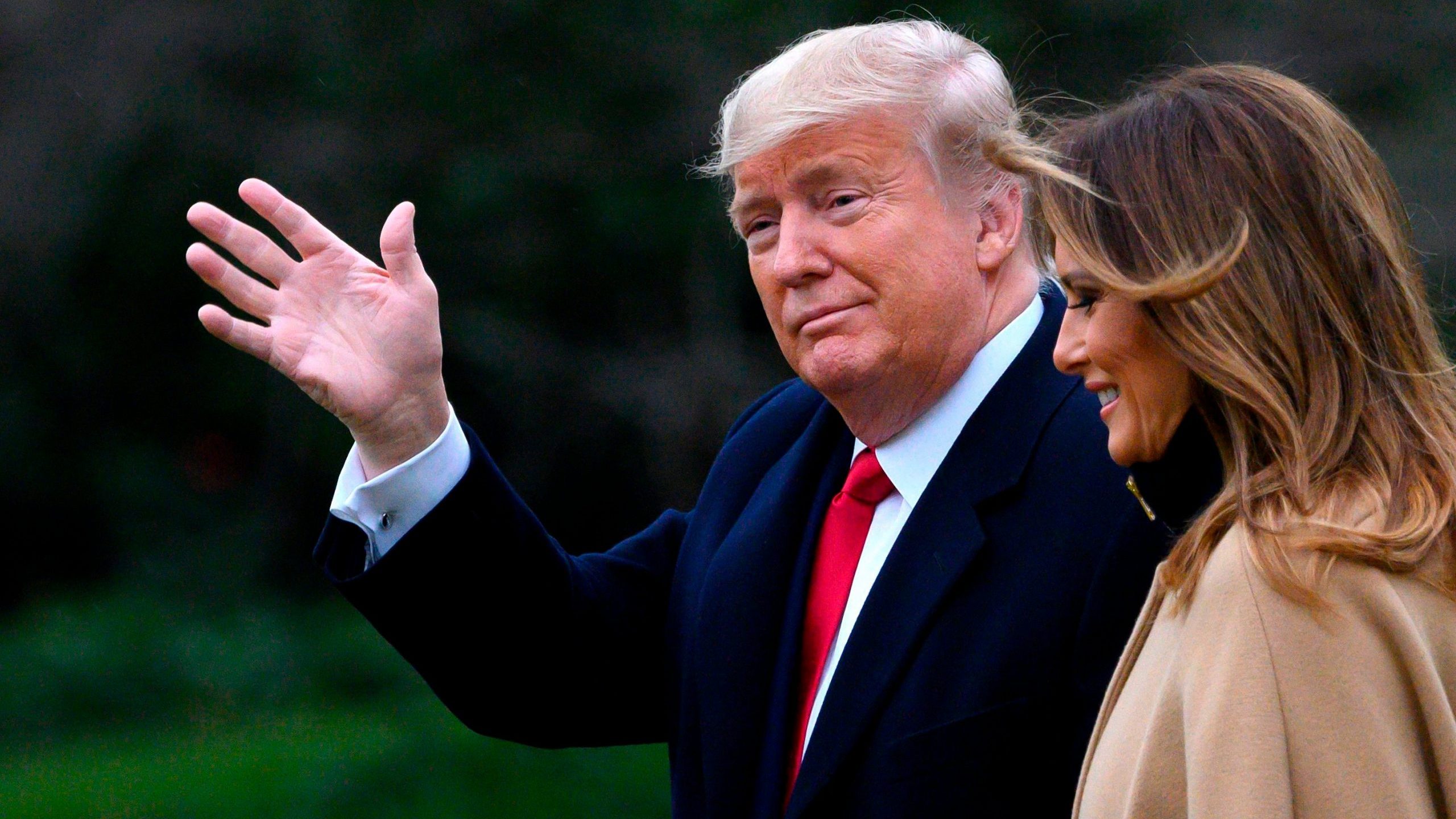 President Donald Trump waves as he and first lady Melania Trump walk to Marine One before departing from the White House on Jan. 31, 2020. (Credit: Andrew Caballero-Reynolds / AFP / Getty Images)