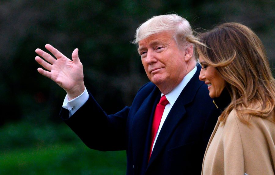 President Donald Trump waves as he and first lady Melania Trump walk to Marine One before departing from the White House on Jan. 31, 2020. (Credit: Andrew Caballero-Reynolds / AFP / Getty Images)