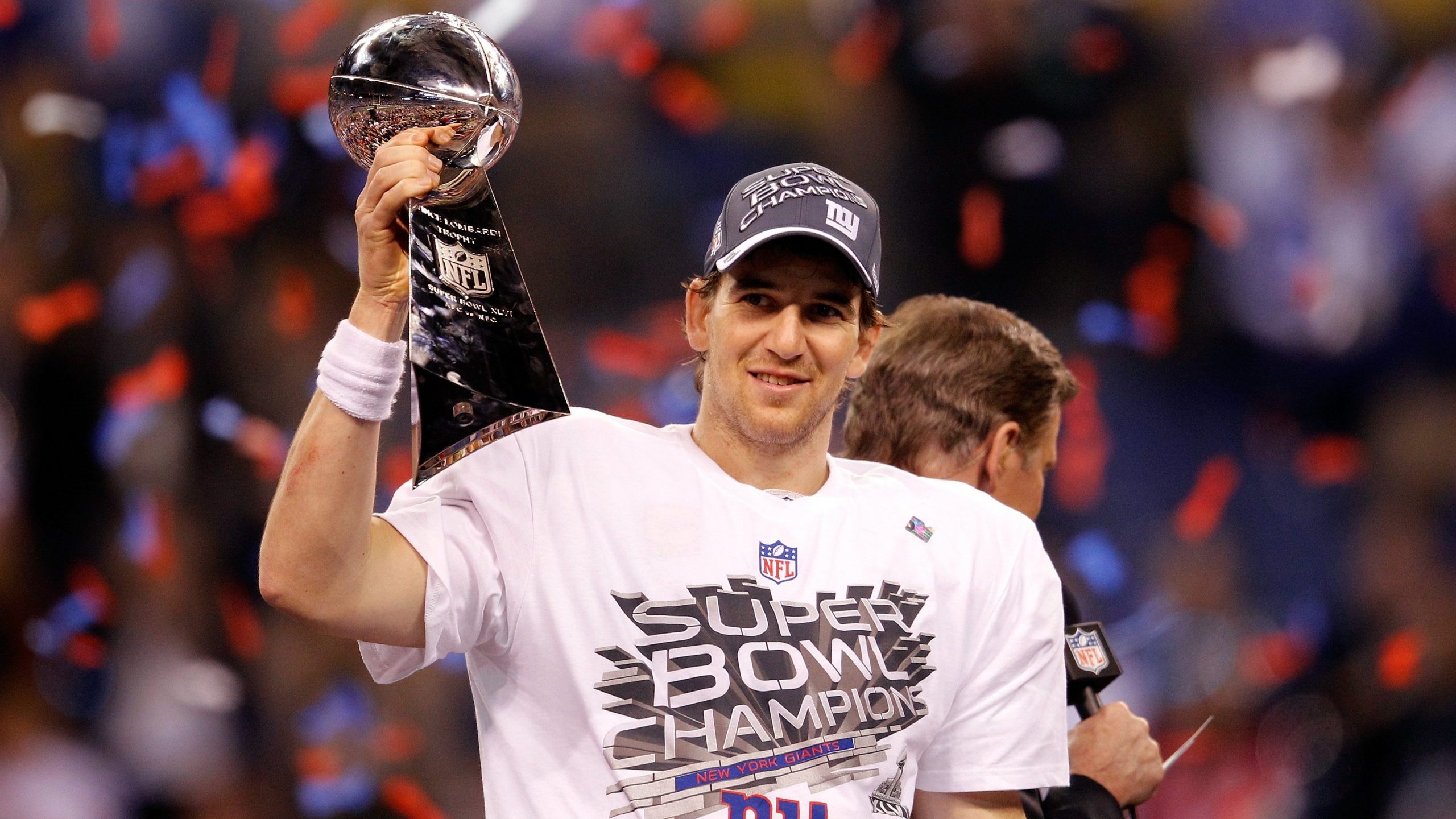 Eli Manning #10 of the New York Giants celebrates with the Vince Lombardi trophy after the Giants won 21-17 against the New England Patriots during Super Bowl XLVI at Lucas Oil Stadium on Feb. 5, 2012 in Indianapolis. (Credit: Rob Carr/Getty Images)