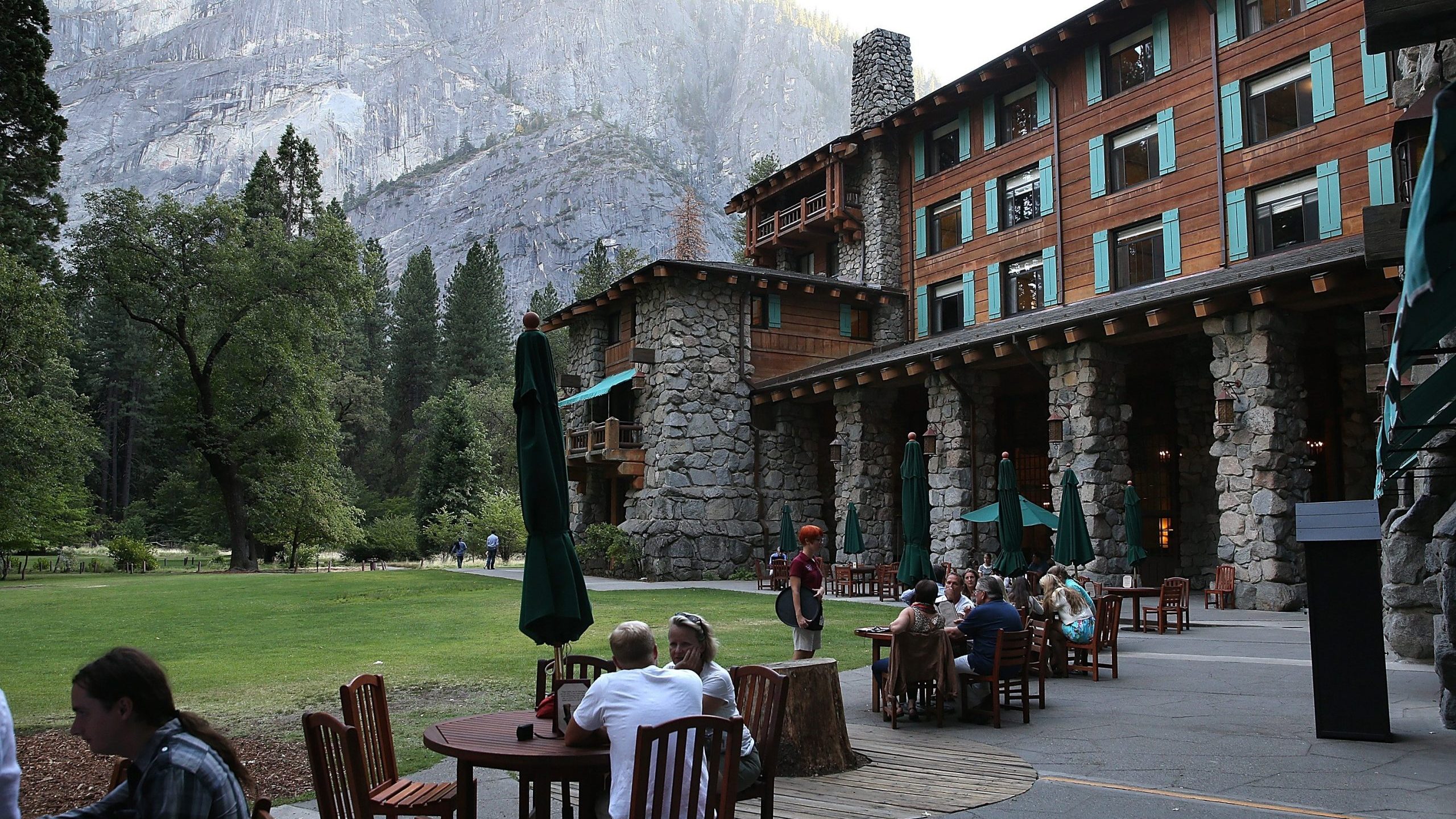 Park visitors sit outside the Ahwahnee Hotel in Yosemite National Park on Aug. 28, 2013. (Credit: Justin Sullivan / Getty Images)