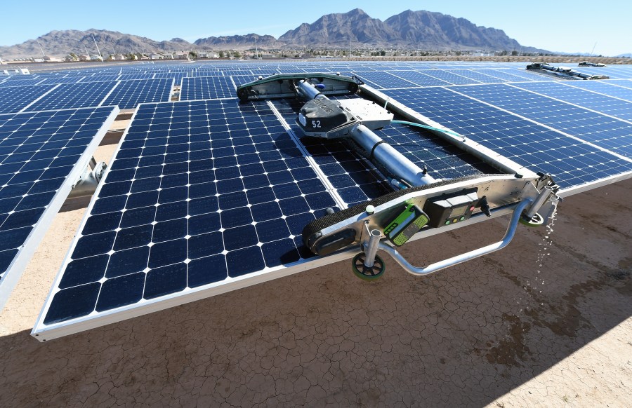 A panel-washing robot cleans a row of solar panels during a dedication ceremony to commemorate the completion of the 102-acre, 15-megawatt Solar Array II Generating Station at Nellis Air Force Base on Feb. 16, 2016, in Las Vegas, Nevada. (Ethan Miller/Getty Images)