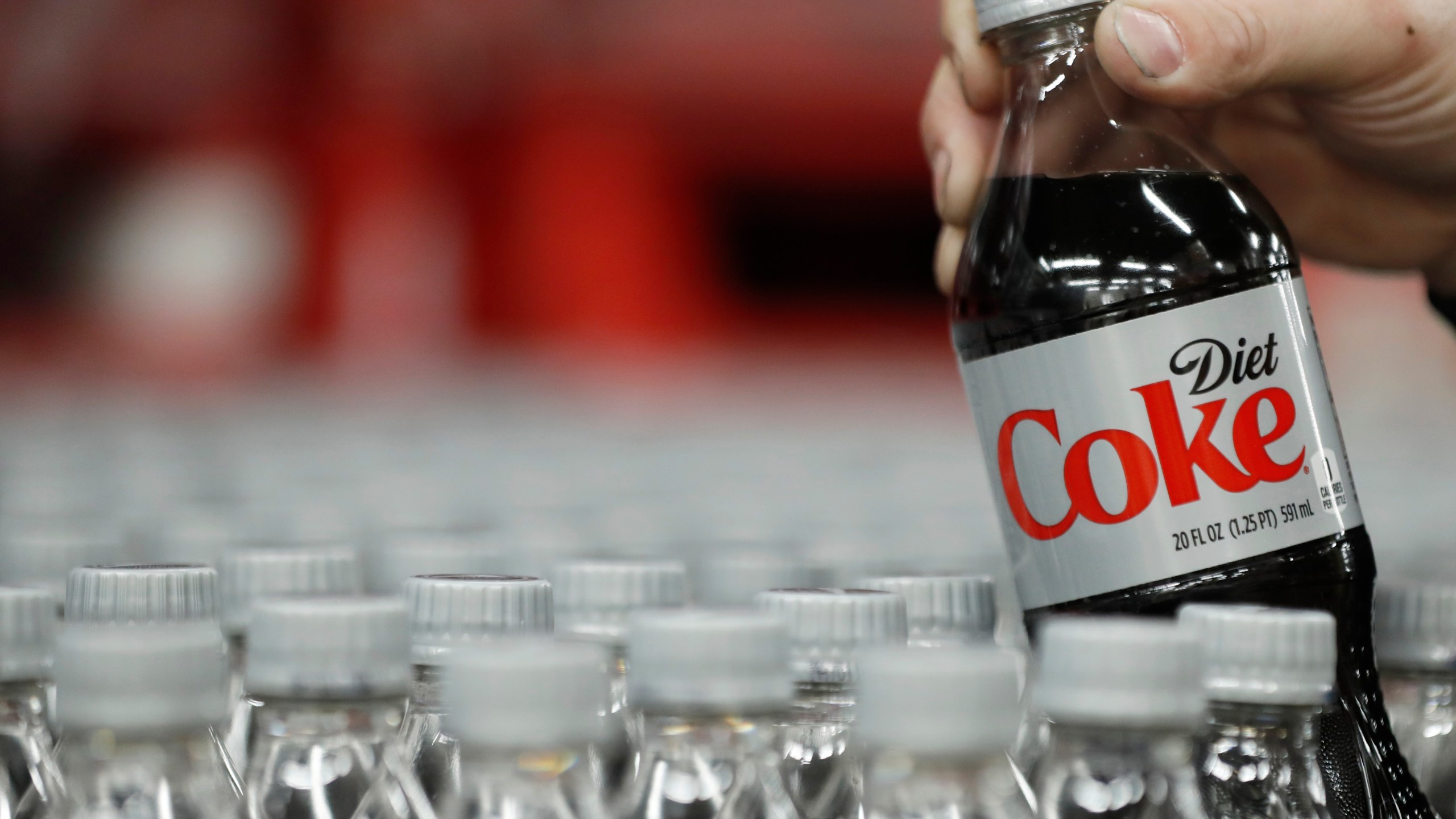 A bottle of Diet Coke is pulled up for a quality control test at a Coco-Cola bottling plant on Feb. 10, 2017, in Salt Lake City, Utah. (Credit: George Frey/Getty Images)