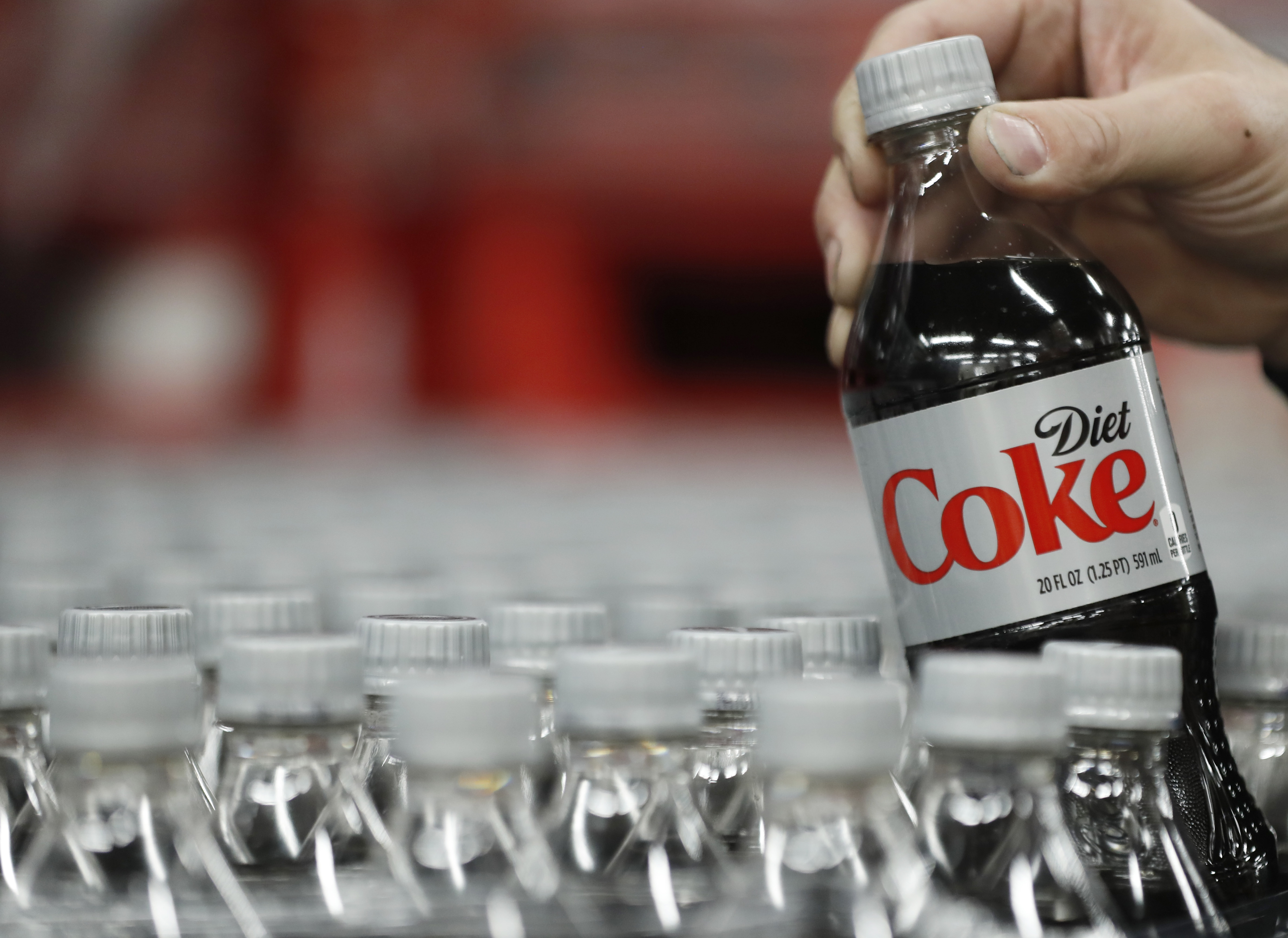 A bottle of Diet Coke is pulled up for a quality control test at a Coco-Cola bottling plant on Feb. 10, 2017, in Salt Lake City, Utah. (Credit: George Frey/Getty Images)