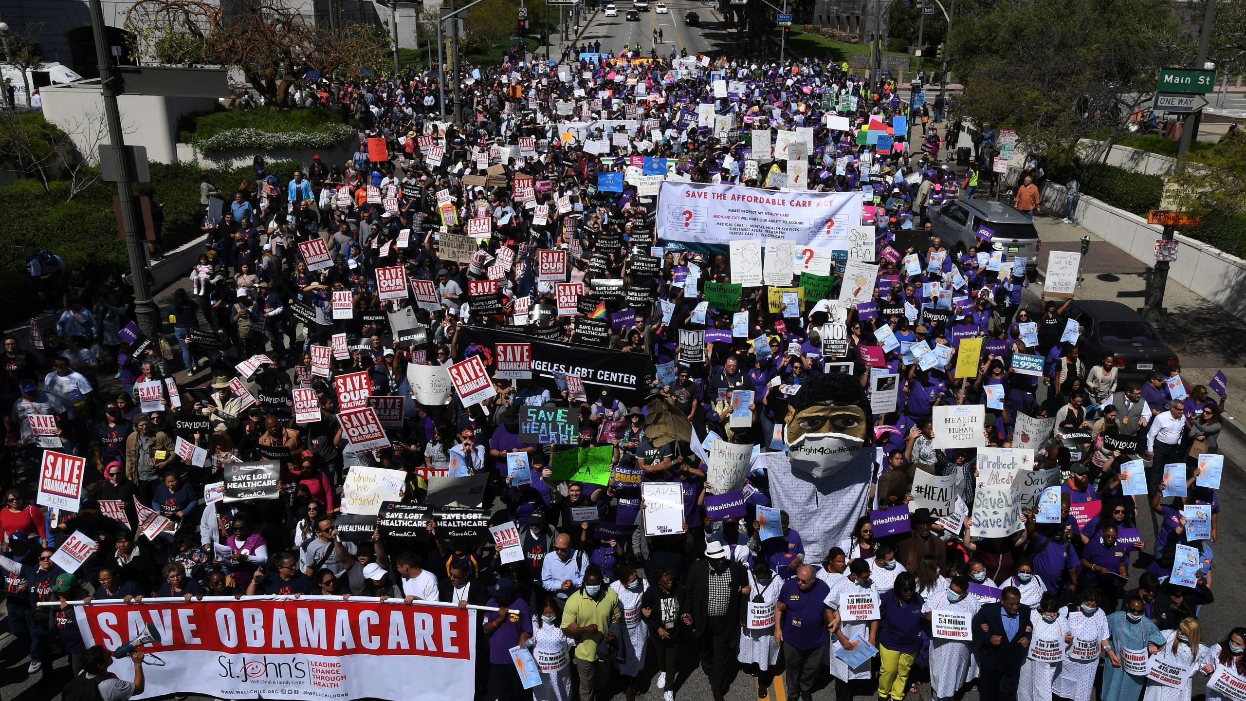 Protesters march towards the Federal Building during a "Save the Affordable Care Act" rally in Los Angeles on March 23, 2017. (Credit: MARK RALSTON/AFP via Getty Images)