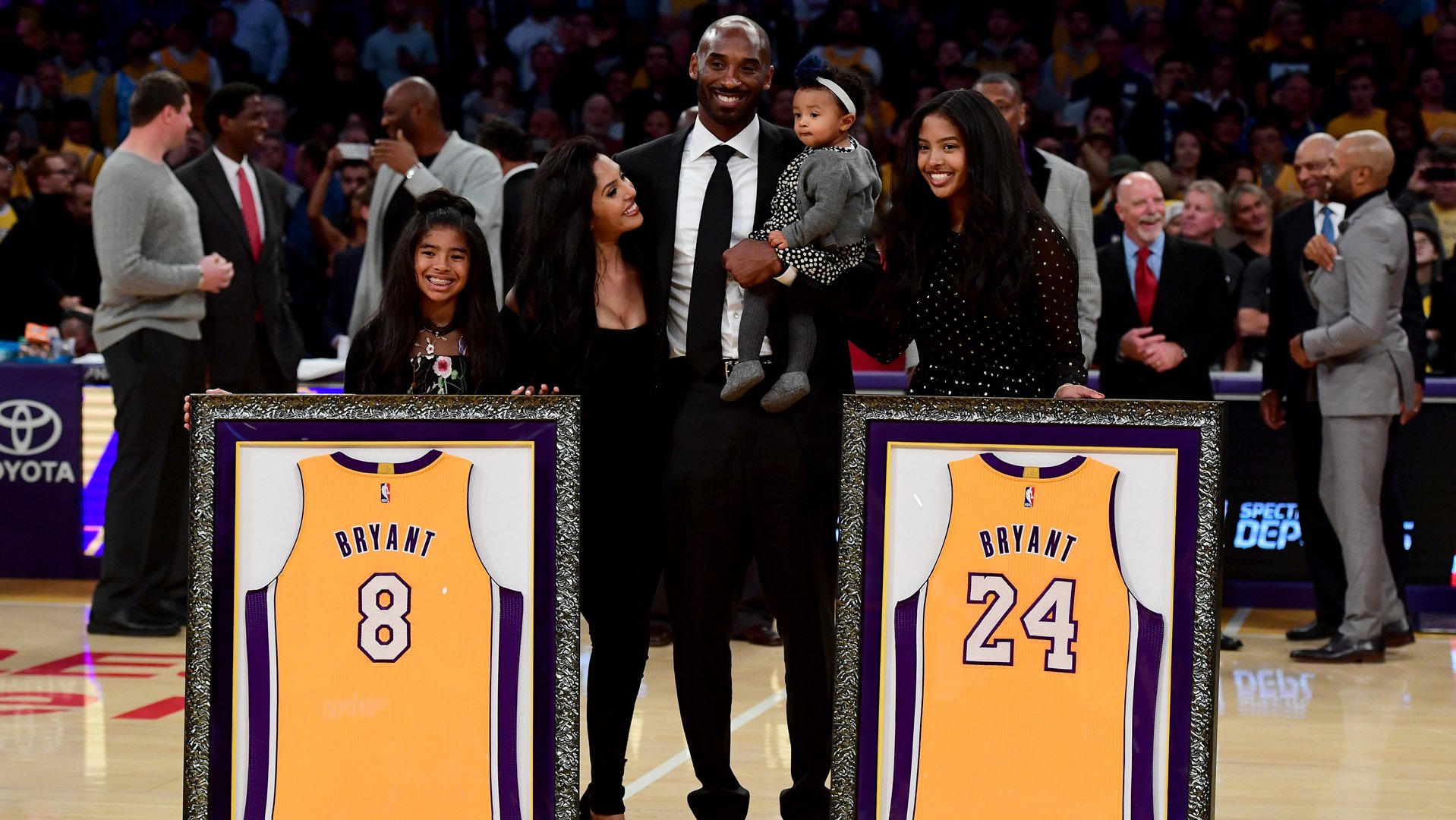 Kobe Bryant poses with his family at halftime after both his #8 and #24 Los Angeles Lakers jerseys are retired at Staples Center on Dec. 18, 2017, in Los Angeles. (Credit: Harry How/Getty Images)