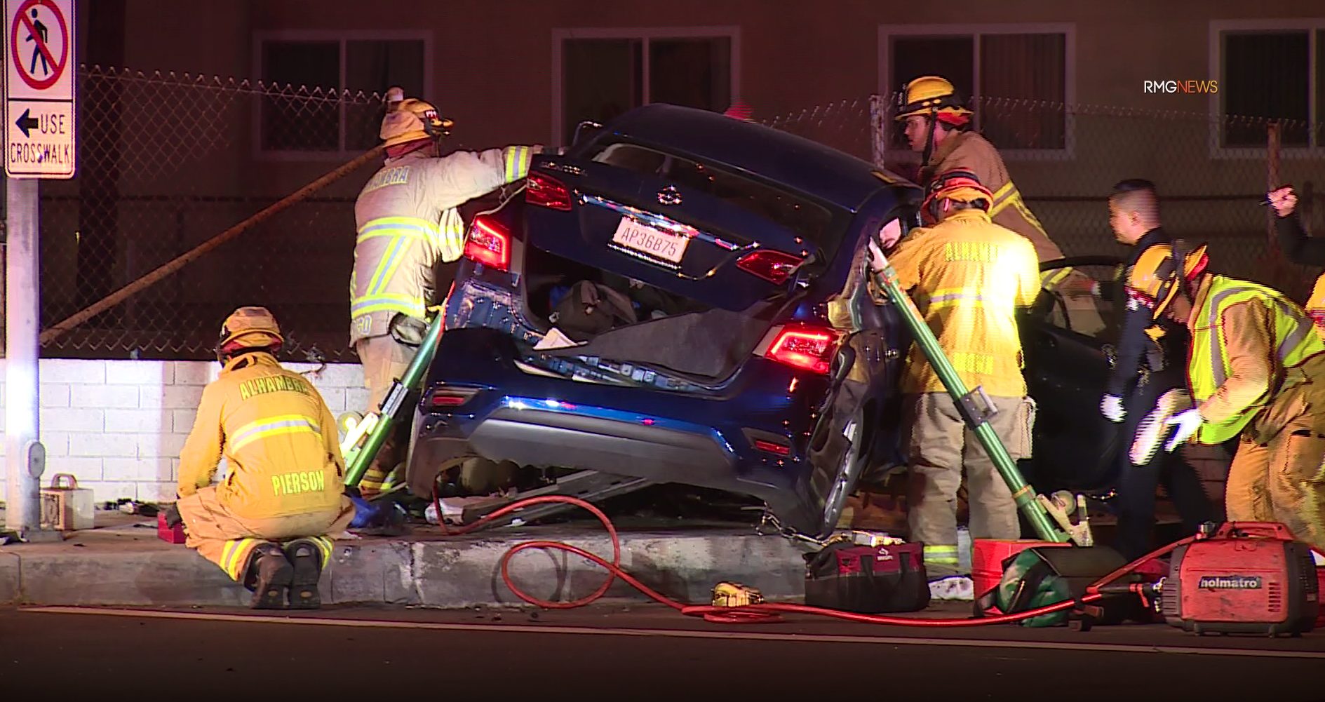 Firefighters rescue a trapped passenger from a car that officials say accelerated towards officers then crashed following a pursuit in Alhambra on Jan. 5, 2019. (Credit: RMG News)