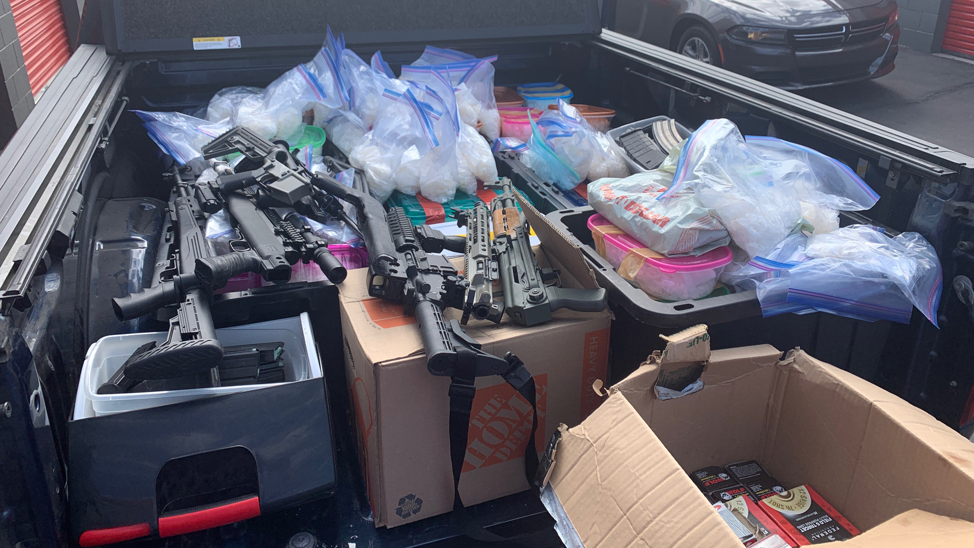 Law enforcement officials display drugs and guns seized during a bust in San Bernardino on Feb. 20 and Feb. 21, 2020. (Credit: U.S. Drug Enforcement Administration)