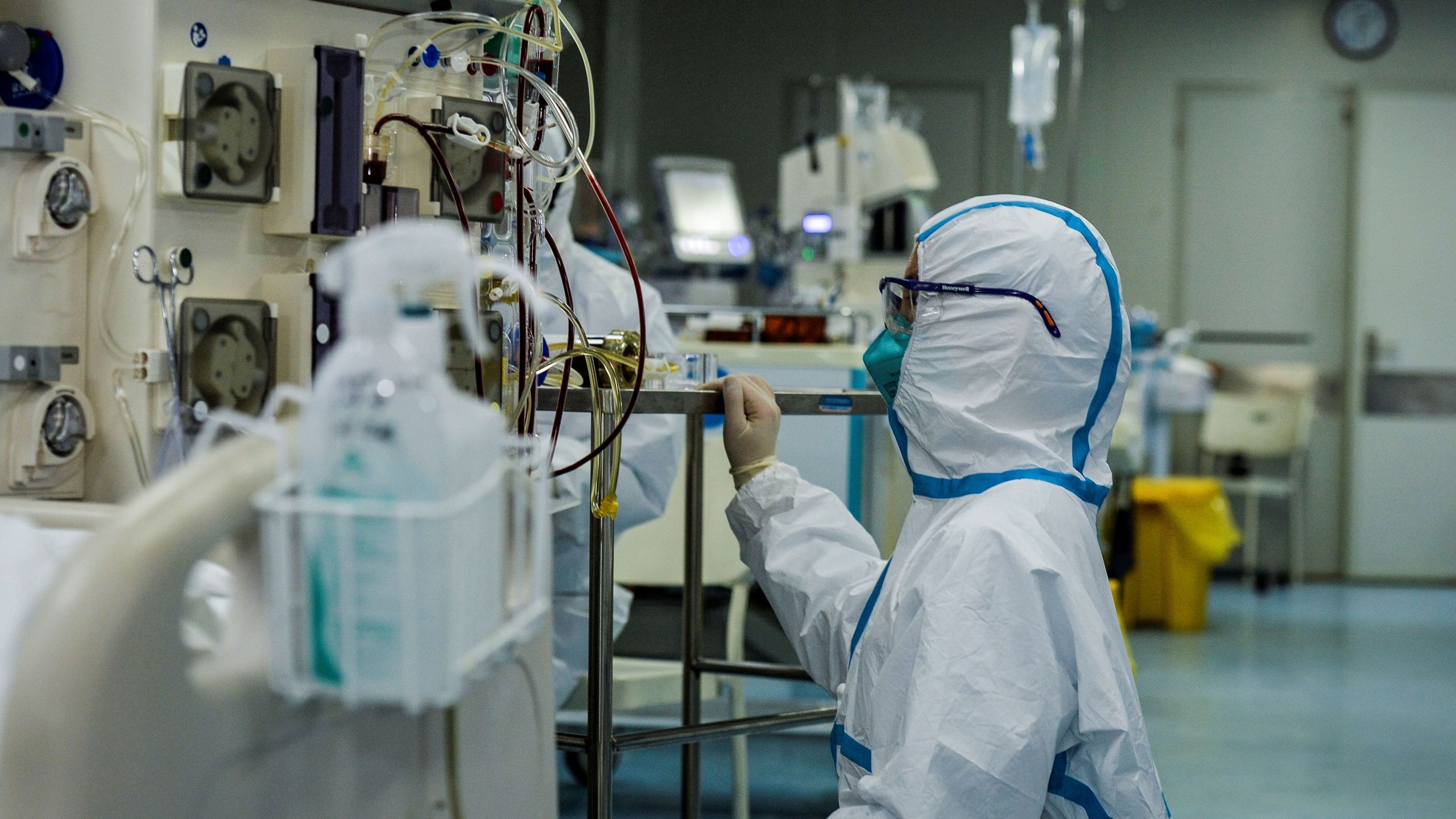 A doctor operates a machine as medical staff treat patients infected with the COVID-19 coronavirus at a hospital in Wuhan in China's central Hubei province on Feb. 24, 2020. (STR/AFP via Getty Images)