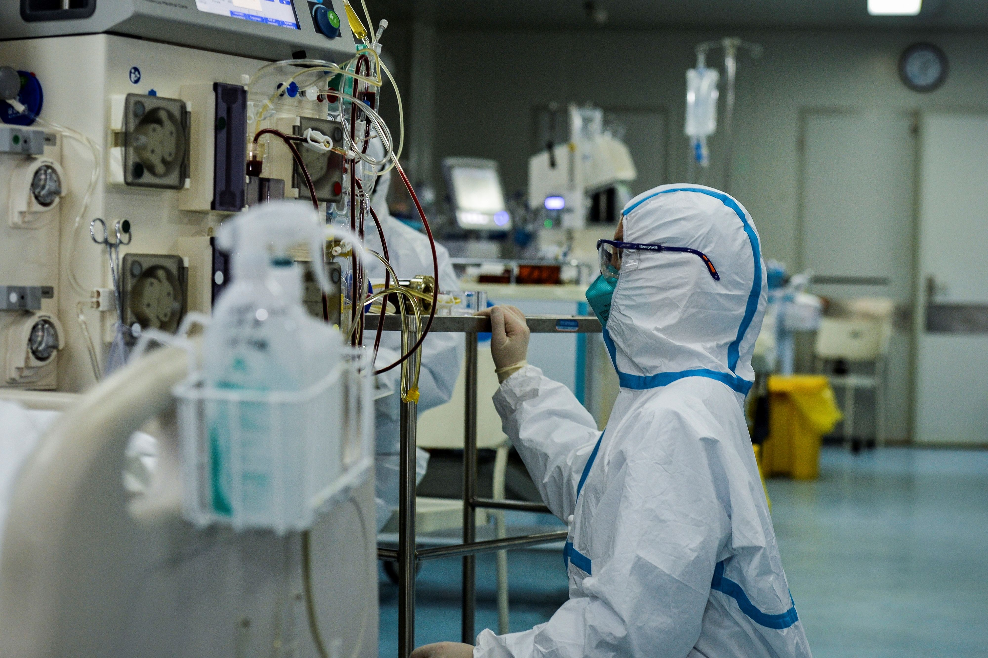 A doctor operates a machine as medical staff treat patients infected with the COVID-19 coronavirus at a hospital in Wuhan in China's central Hubei province on Feb. 24, 2020. (STR/AFP via Getty Images)