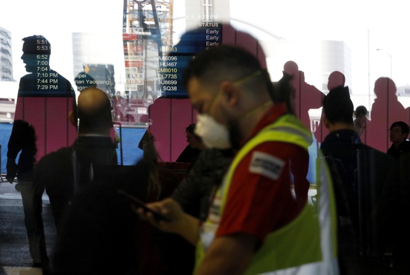 An airport worker wears a mask amid fears of coronavirus at the Tom Bradley International Terminal at Los Angeles International Airport on Feb. 8. (Genaro Molina / Los Angeles Times)