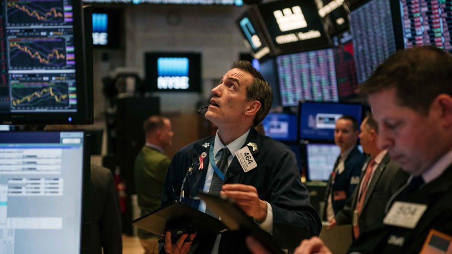 Traders work through the closing minutes of trading Tuesday on the New York Stock Exchange floor on Feb. 25, 2020, in New York City. (Scott Heins/Getty Images)