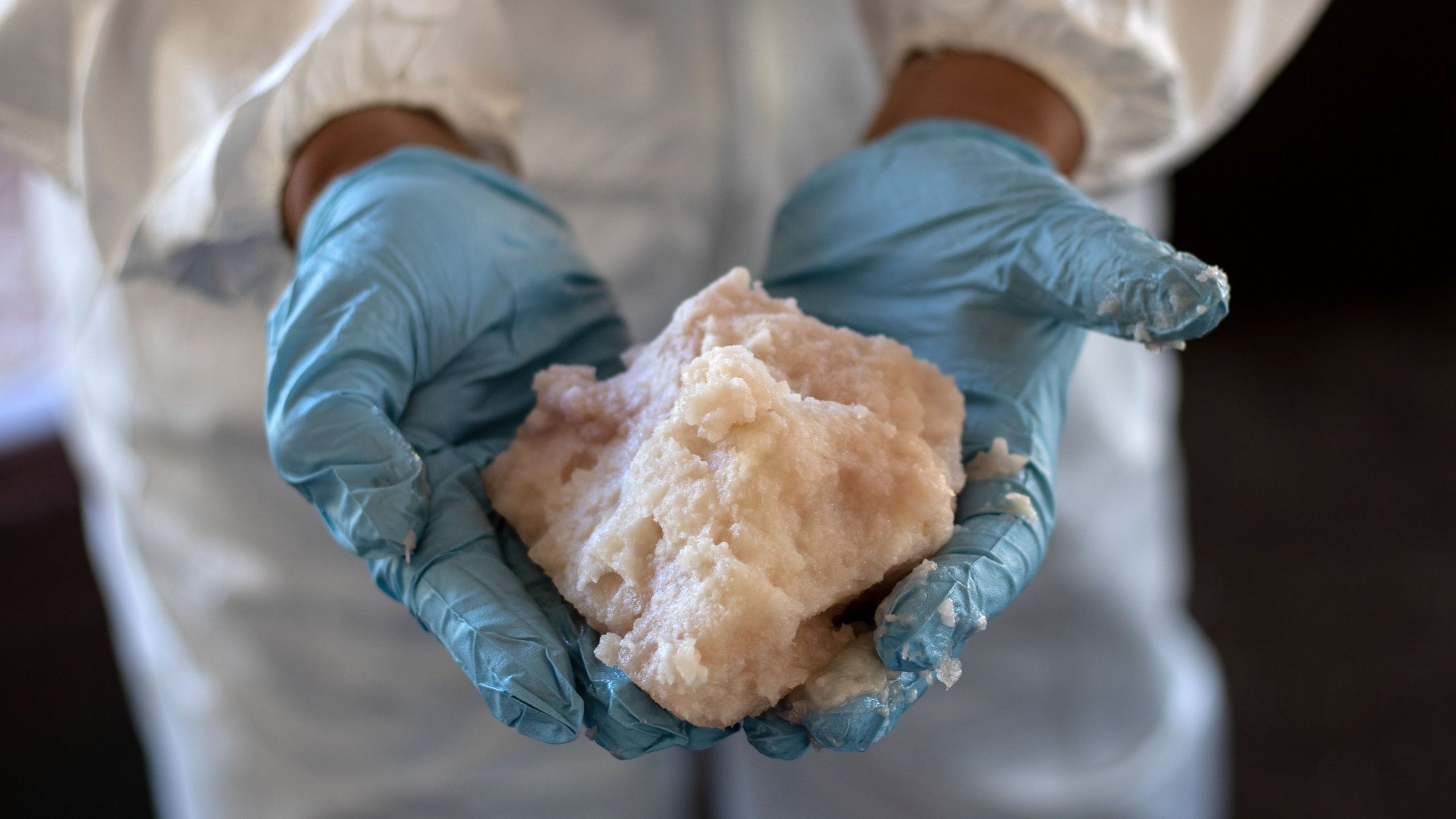 A Mexican Army expert shows crystal meth paste at a clandestine laboratory near la Rumorosa town in Tecate, Baja California state, Mexico on Aug. 28, 2018. (Credit: Guillermo Arias/AFP via Getty Images)