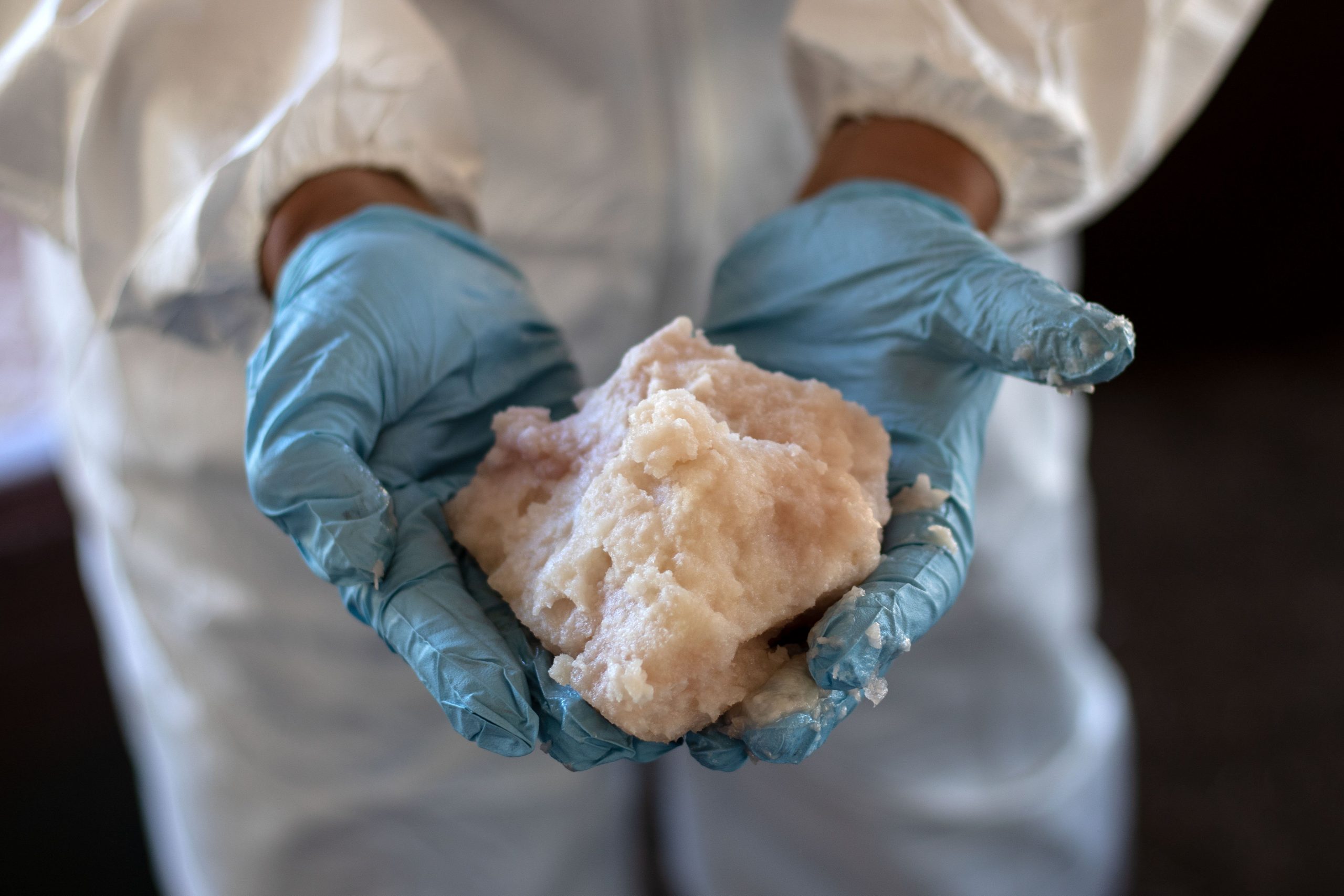 A Mexican Army expert shows crystal meth paste at a clandestine laboratory near la Rumorosa town in Tecate, Baja California state, Mexico on Aug. 28, 2018. (Credit: Guillermo Arias/AFP via Getty Images)