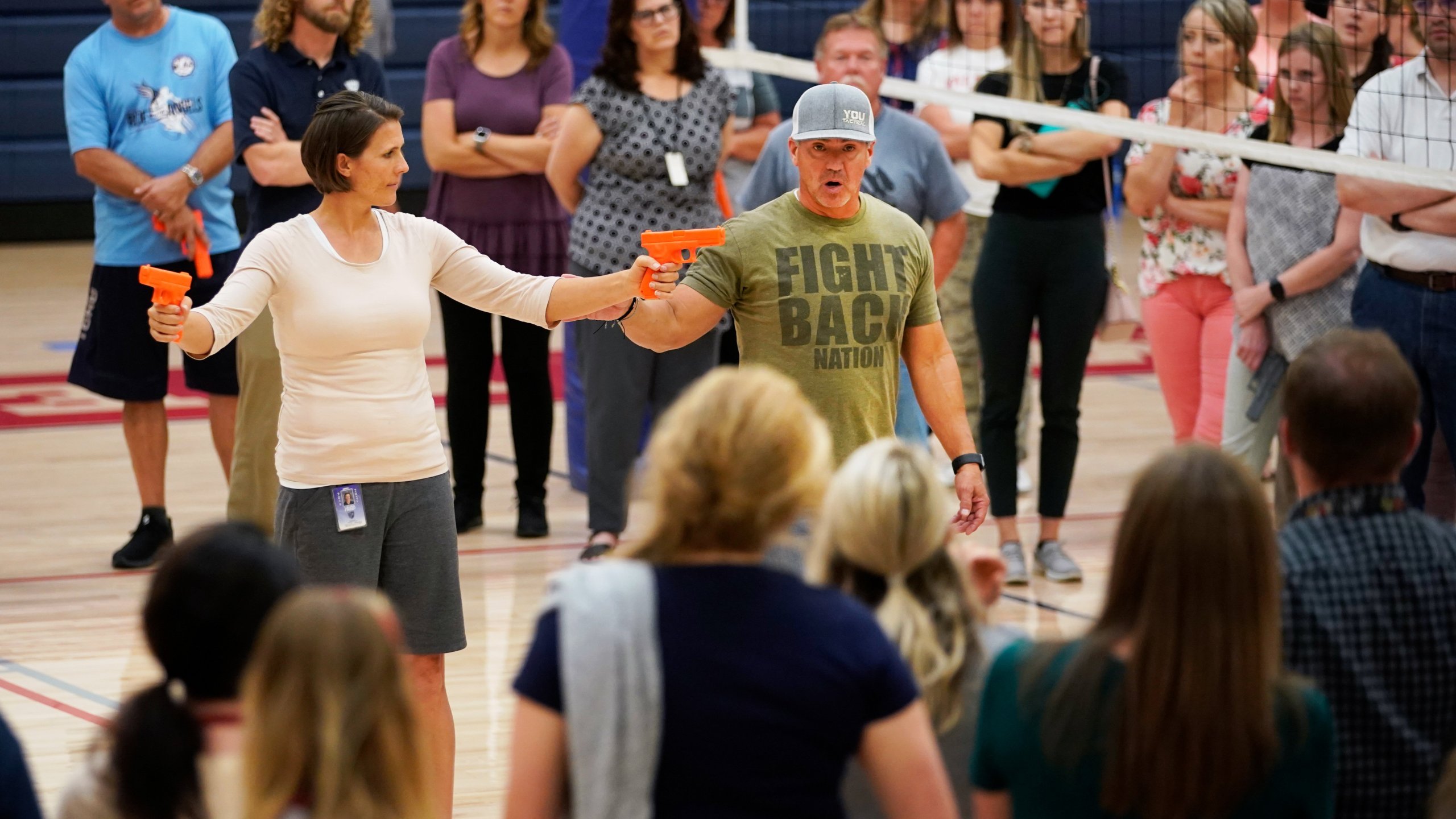 A man uses dummy handguns as he demonstrates with a teacher how to disarm a shooter and fight back during an active shooter event on Sept. 4, 2019, in Provo, Utah. (Credit: George Frey/Getty Images)