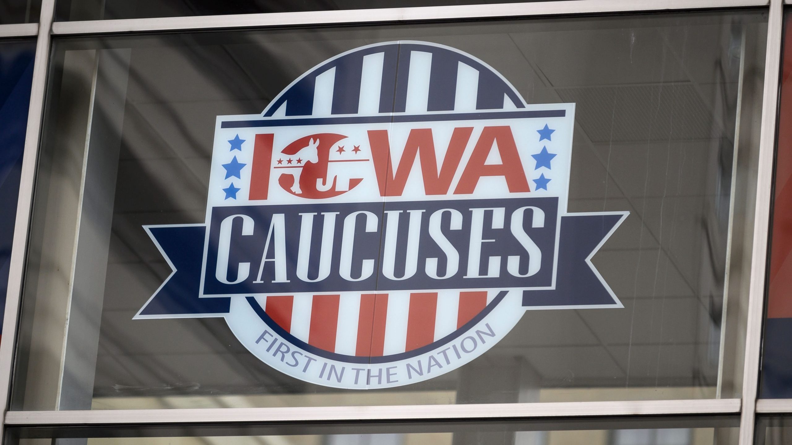 A sign for the Iowa caucuses hangs in downtown Des Moines, Iowa, on Jan. 25, 2020. (Credit: STEPHEN MATUREN/AFP via Getty Images)