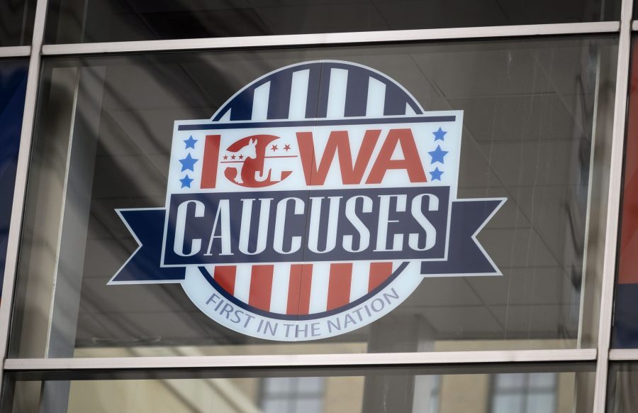 A sign for the Iowa caucuses hangs in downtown Des Moines, Iowa, on Jan. 25, 2020. (Credit: STEPHEN MATUREN/AFP via Getty Images)