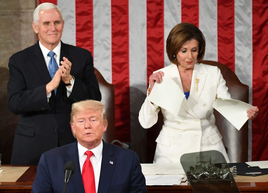 US Vice President Mike Pence claps as Speaker of the US House of Representatives Nancy Pelosi appears to rip a copy of US President Donald Trumps speech after he delivers the State of the Union address at the US Capitol in Washington, DC, on February 4, 2020. (Credit: MANDEL NGAN/AFP via Getty Images)