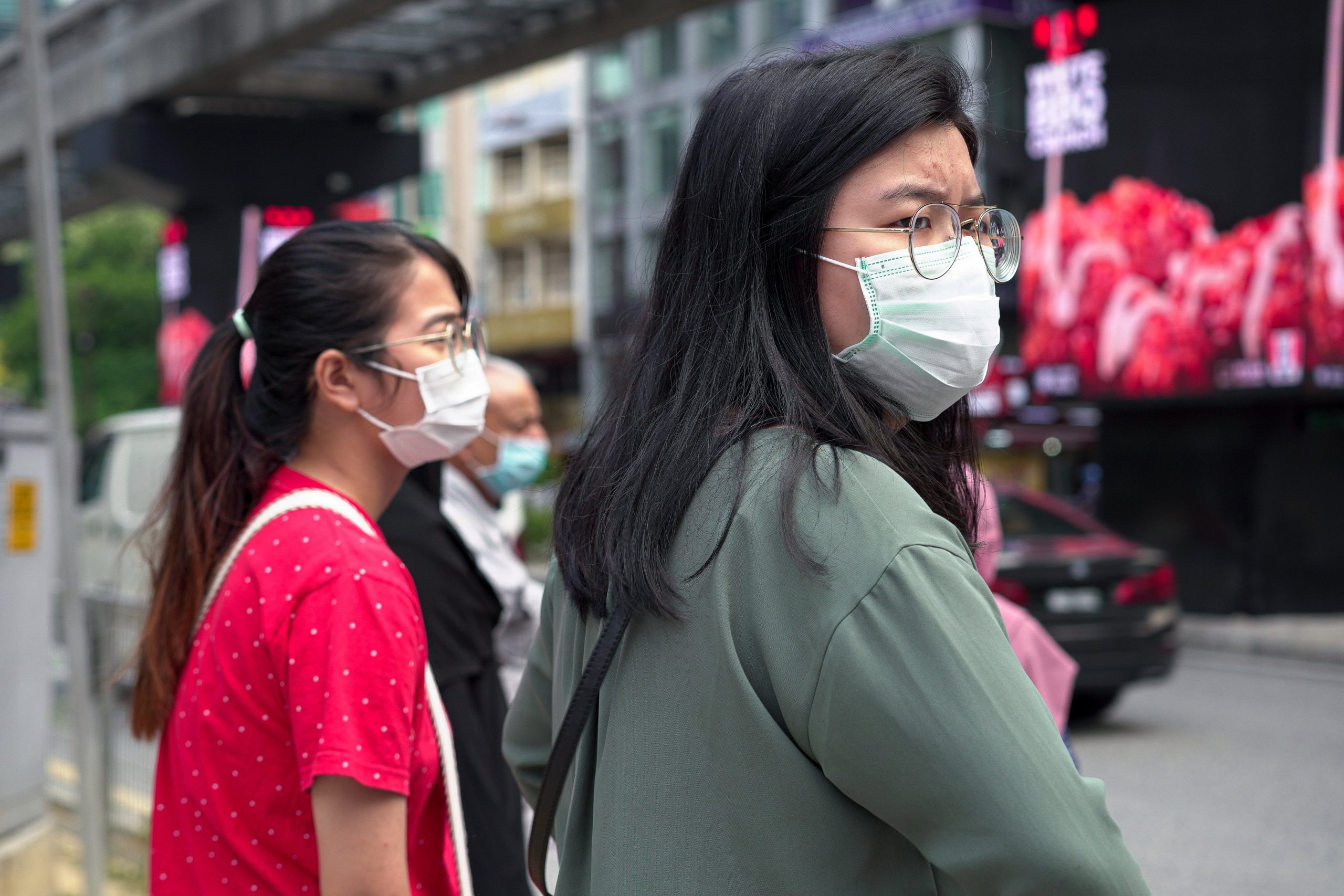 Visitors wearing masks wait at a traffic junction in Bukit Bintang district on Feb. 5, 2020, in Kuala Lumpur, Malaysia. The coronavirus, originating in Wuhan, China, has spread around the globe. (Credit: Ore Huiying/Getty Images)