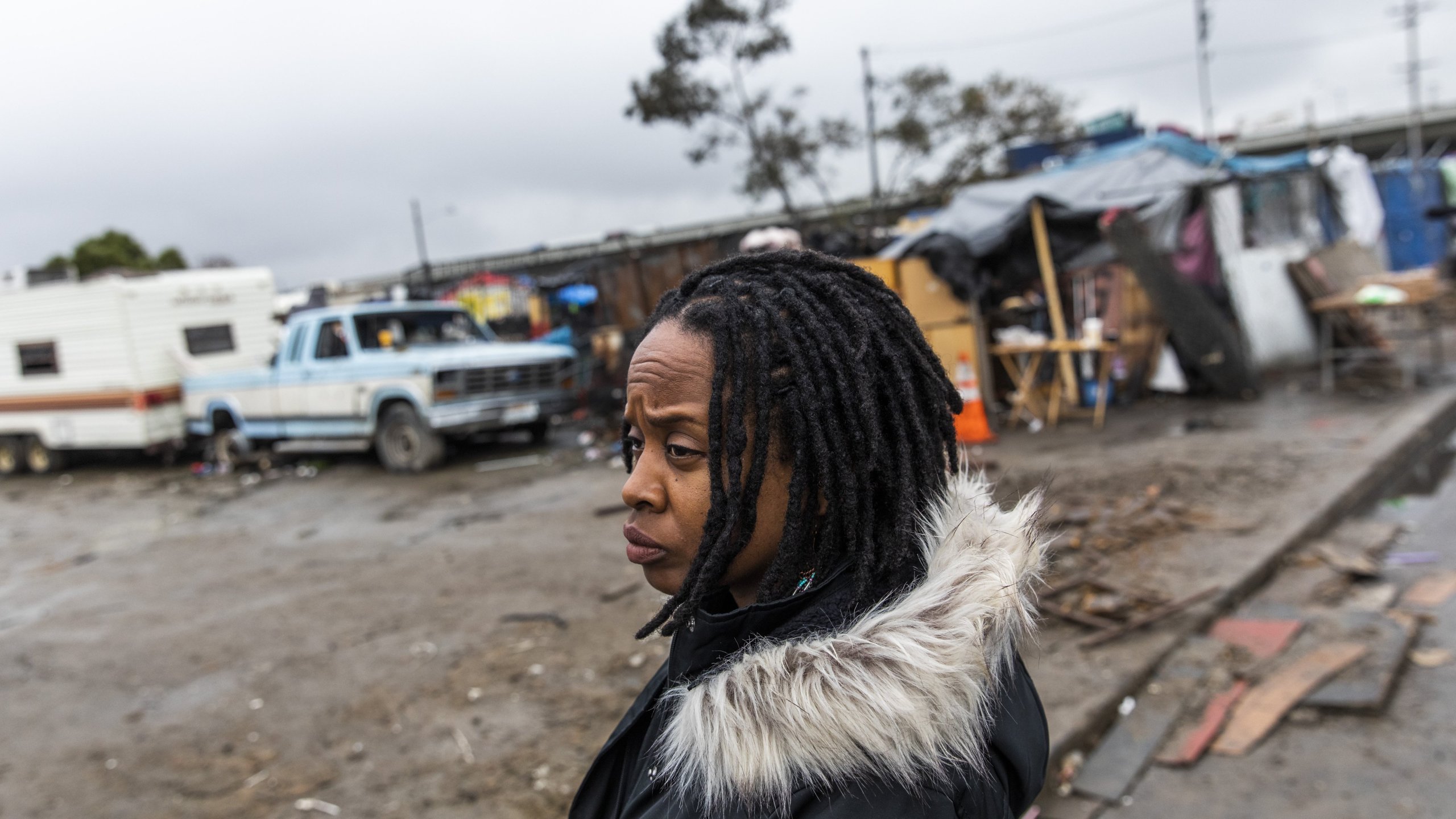 Carroll Fife, director of the Oakland office for the Alliance of Californians for Community Empowerment, stands outside a homeless encampment in Oakland on Jan. 28, 2020. (Credit: Philip Pacheco / AFP / Getty Images)