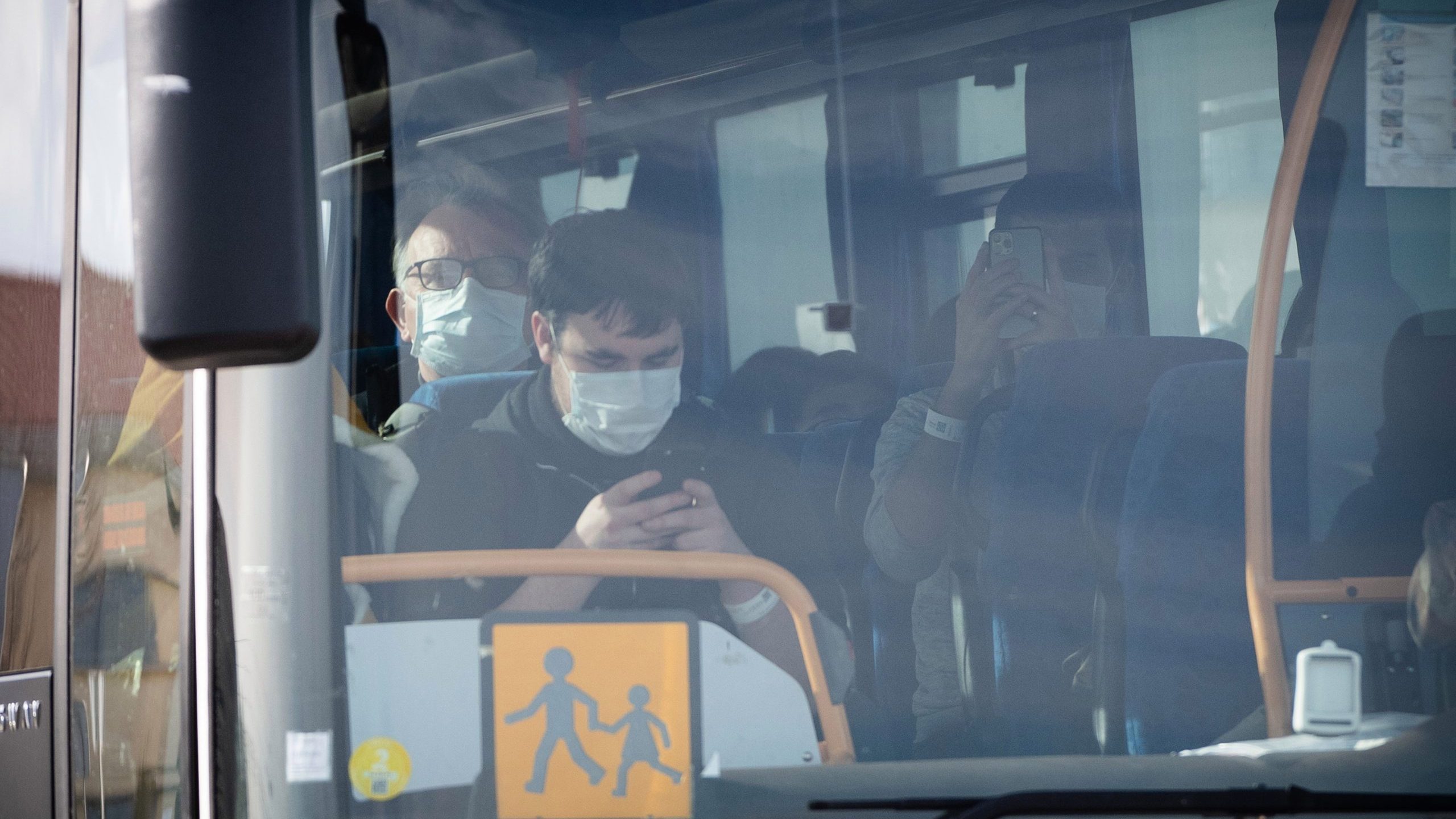 A bus carry people disembarked from an aircraft leaves the Istres-Le Tube Air Base near Istres, northwest of Marseille, southern France, on Feb. 9, 2020, the aircraft believed to be carrying European citizens flown out from the coronavirus zone in Wuhan, China.(Credit: CLEMENT MAHOUDEAU / AFP) (Photo by CLEMENT MAHOUDEAU/AFP via Getty Images)