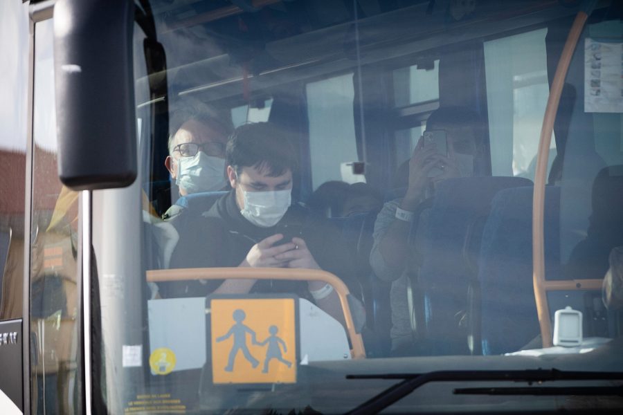 A bus carry people disembarked from an aircraft leaves the Istres-Le Tube Air Base near Istres, northwest of Marseille, southern France, on Feb. 9, 2020, the aircraft believed to be carrying European citizens flown out from the coronavirus zone in Wuhan, China.(Credit: CLEMENT MAHOUDEAU / AFP) (Photo by CLEMENT MAHOUDEAU/AFP via Getty Images)