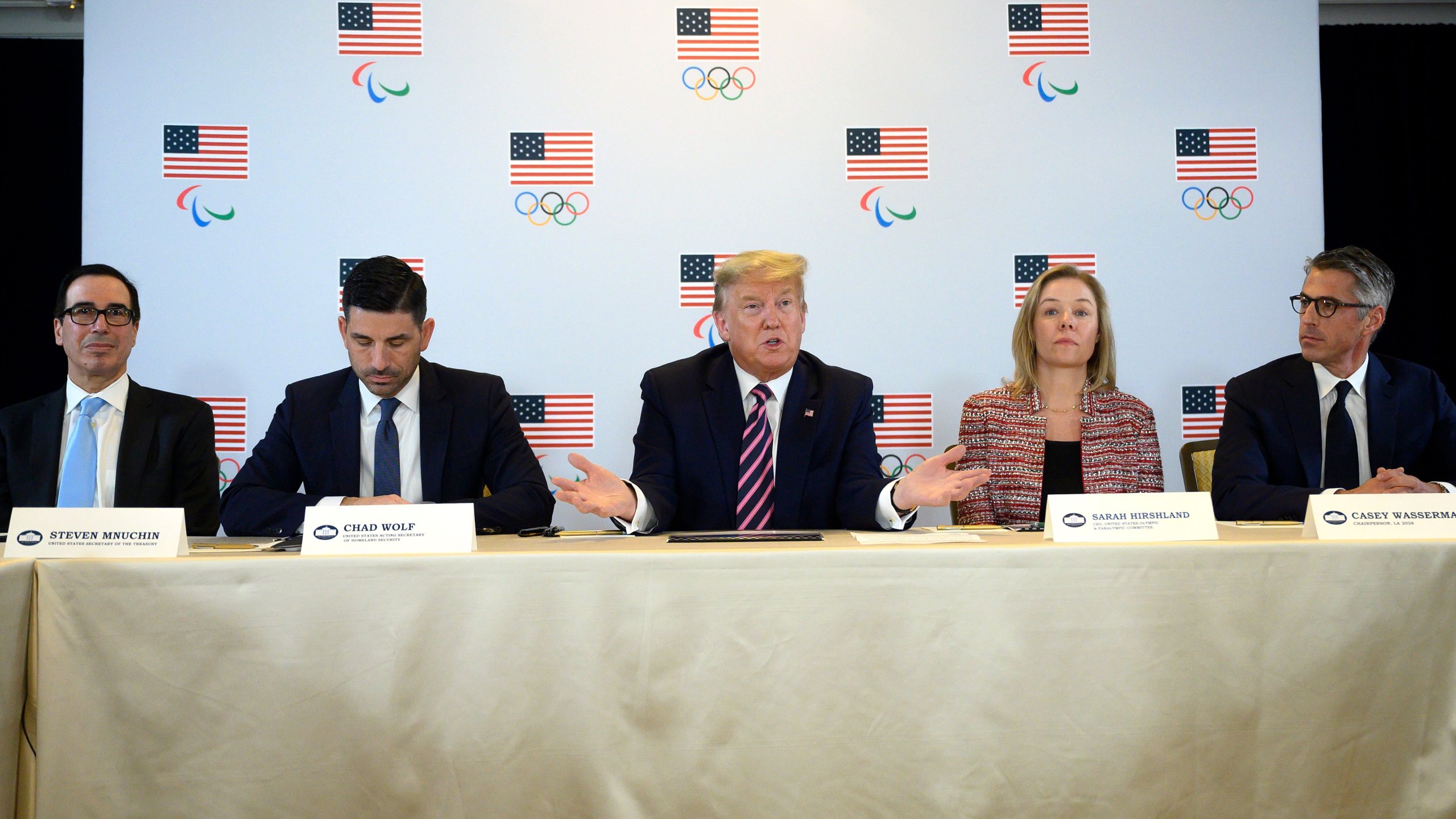 Treasury Secretary Steven Mnuchin, Acting Homeland Security Secretary Chad Wolf, US President Donald Trump, US Olympic & Paralympic Committee CEO Sarah Hirshland and Chairman of LA 2028 Casey Wasserman participate in a briefing with the US Olympic and Paralympic Committee and LA 2028 Organizers in Beverly Hills on Feb. 18, 2020. (Credit: JIM WATSON/AFP via Getty Images)