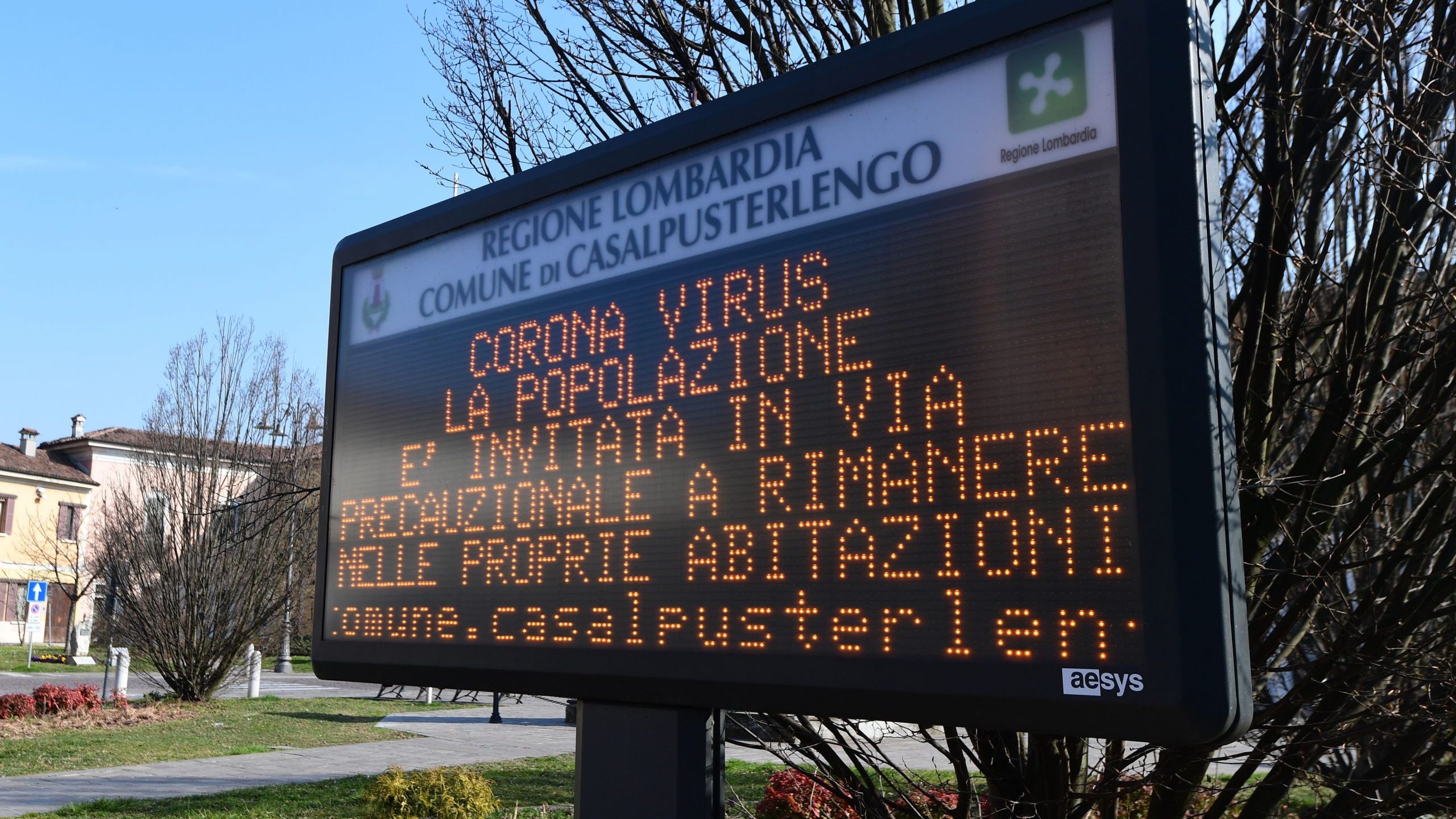 A municipal information sign reading "Coronavirus, the population is invited as a precautionary measure to remain at home" is seen in the village of Casalpusterlengo, southeast of Milan, on Feb. 22, 2020. (Credit: MIGUEL MEDINA/AFP via Getty Images)