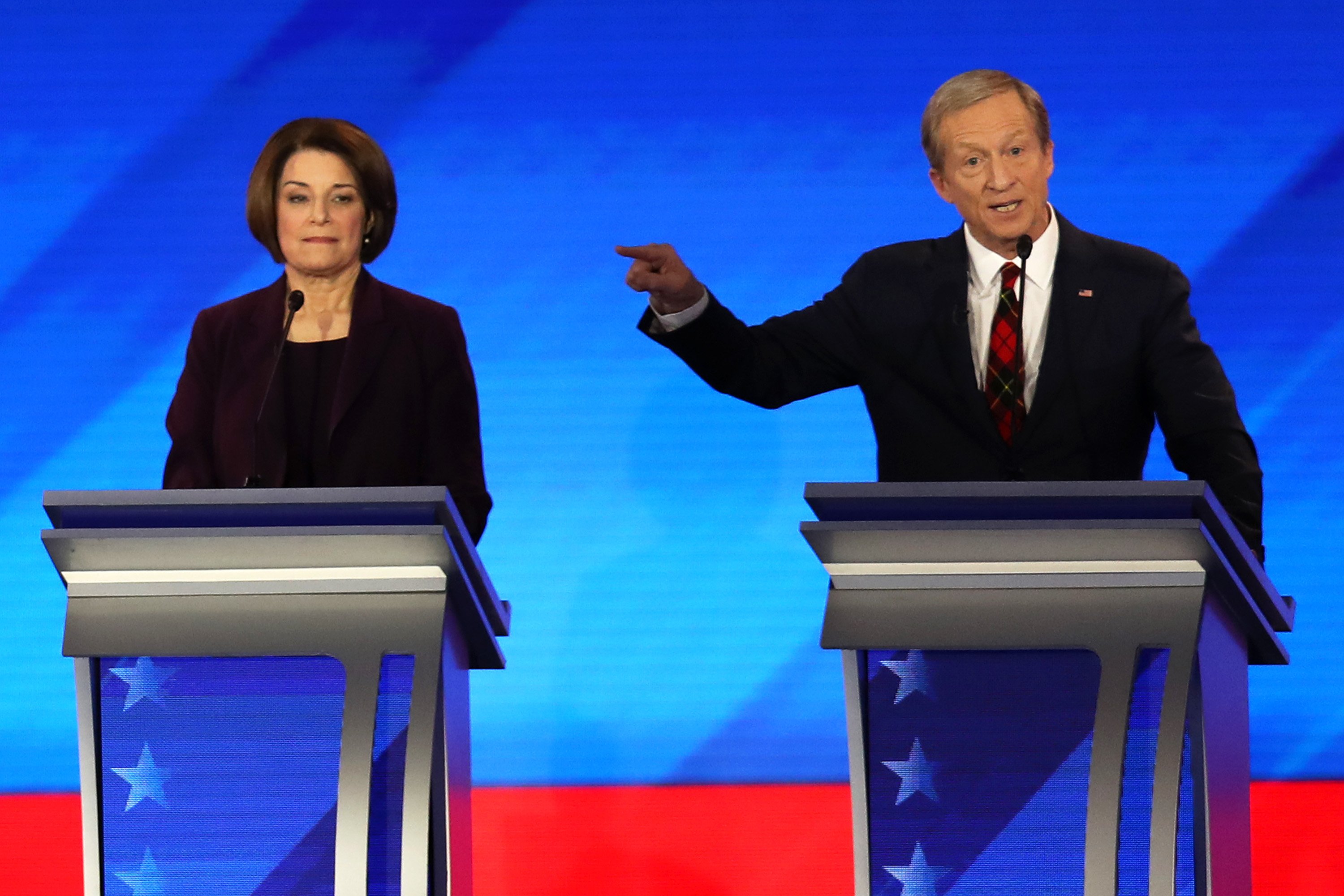 Democratic presidential candidates Sen. Amy Klobuchar (D-MN) and Tom Steyer participate in the Democratic presidential primary debate in the Sullivan Arena at St. Anselm College on Feb. 7, 2020, in Manchester, New Hampshire. (Credit: Joe Raedle/Getty Images)