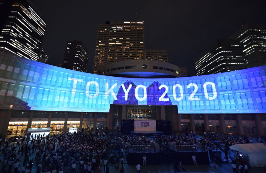 A projection that reads "Tokyo 2020" is seen during a ceremony marking three years to go before the start of the Tokyo 2020 Olympic games at the Tokyo Metropolitan Assembly Building on July 24, 2017. (Credit: KAZUHIRO NOGI/AFP via Getty Images)