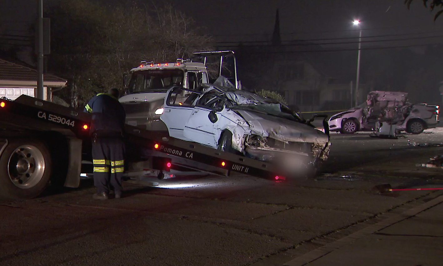 Crews tow away two vehicles that were involved in a deadly crash near Ramona Avenue and Howard Street in Montclair on Feb. 8, 2020. (Credit: KTLA)