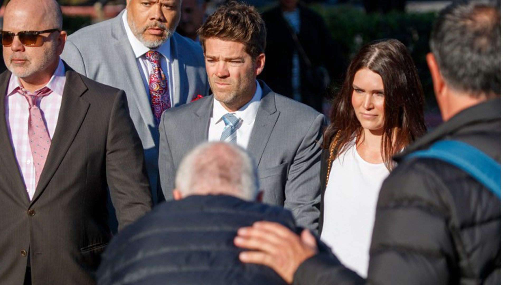 Dr. Grant Robicheaux, center, and girlfriend Cerissa Riley arrive at the Harbor Justice Center in Newport Beach on Feb. 7, 2020.(Credit: Allen J. Schaben / Los Angeles Times)