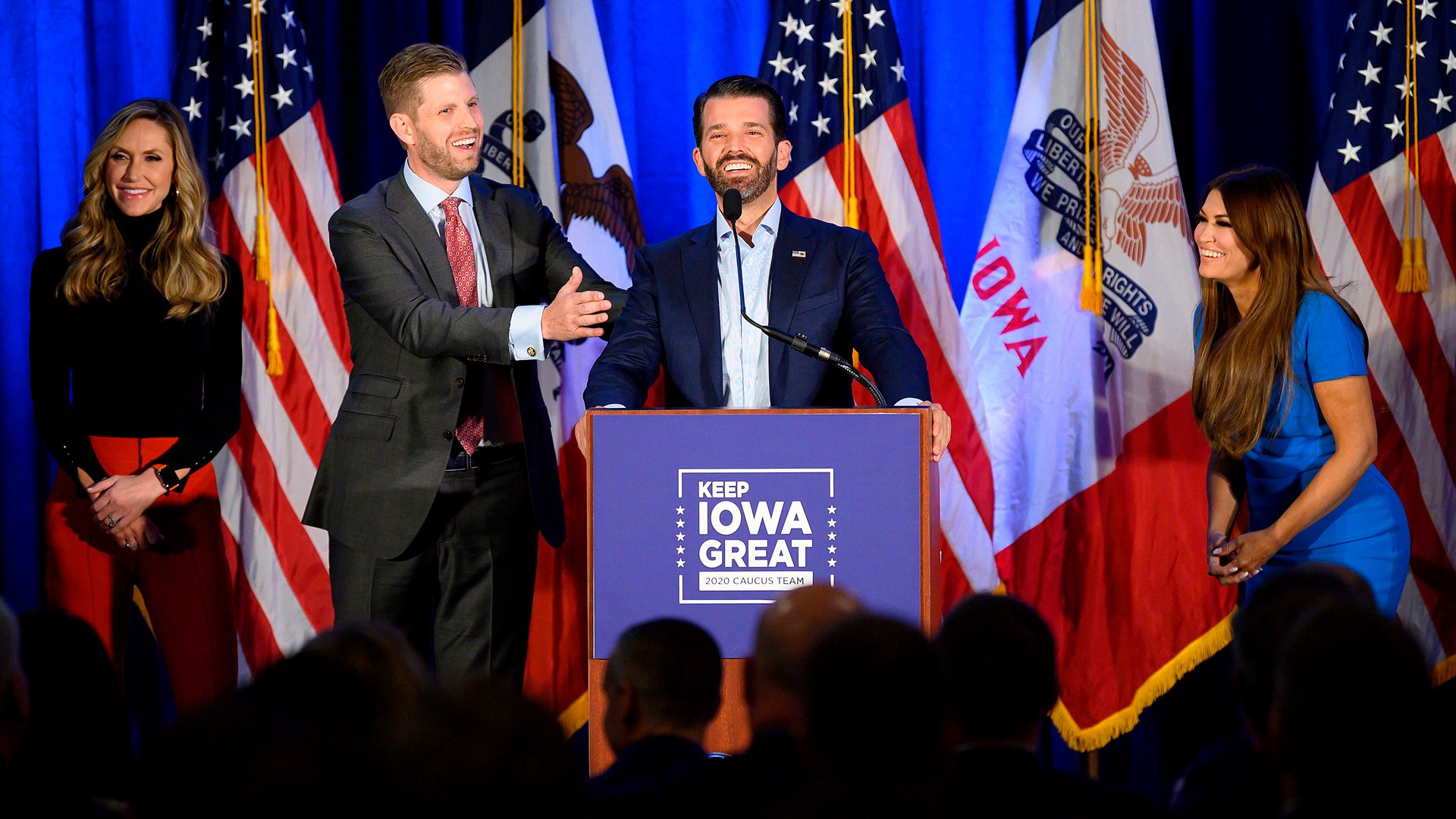 Donald Trump Jr., center, speaks with his brother Eric, second left, and wife Lara, as well as his girlfriend Kimberly Guilfoyle, right, during a "Keep Iowa Great" press conference in Des Moines, Iowa, on Feb. 3, 2020. (Credit: JIM WATSON/AFP via Getty Images)