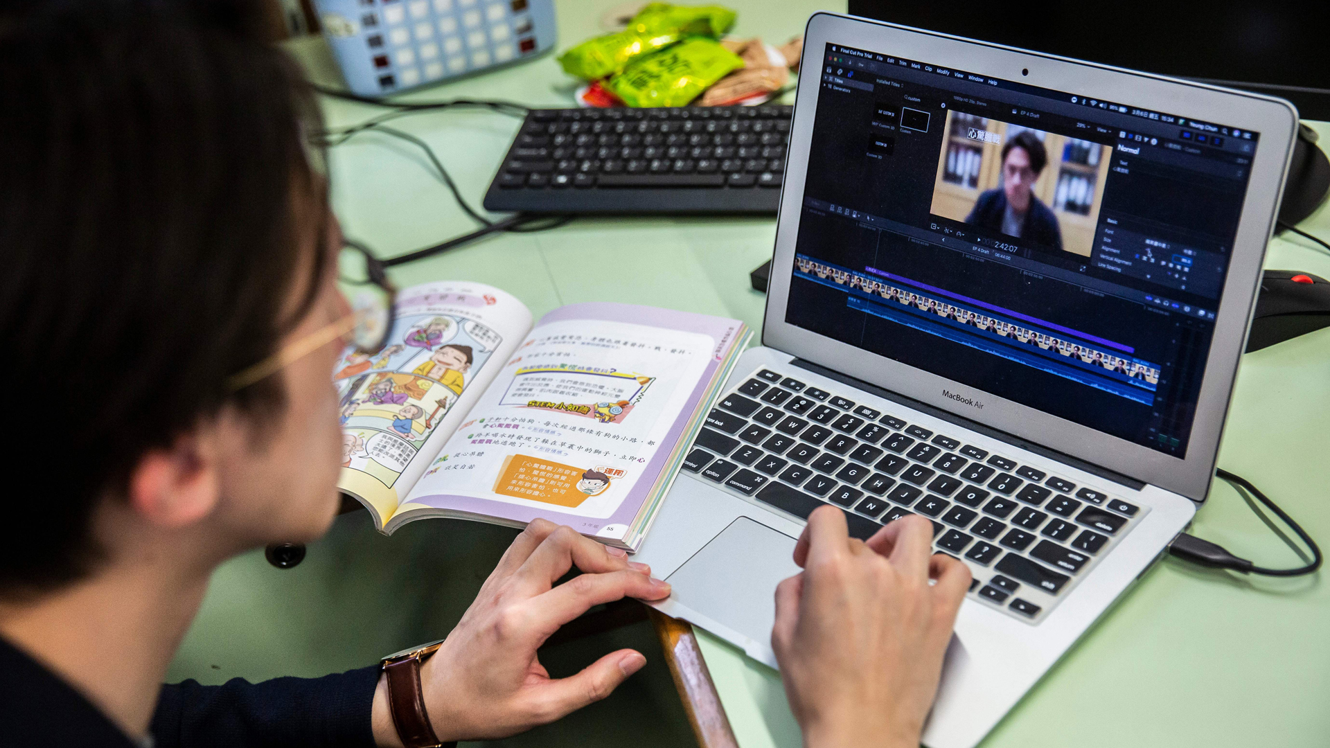 In this photo taken on March 6, 2020, primary school teacher Billy Yeung edits a video lesson he recorded in an empty classroom, for his students who have had their classes suspended due to the COVID-19 coronavirus, in Hong Kong. (Isaac Lawrence/AFP/Getty Images)