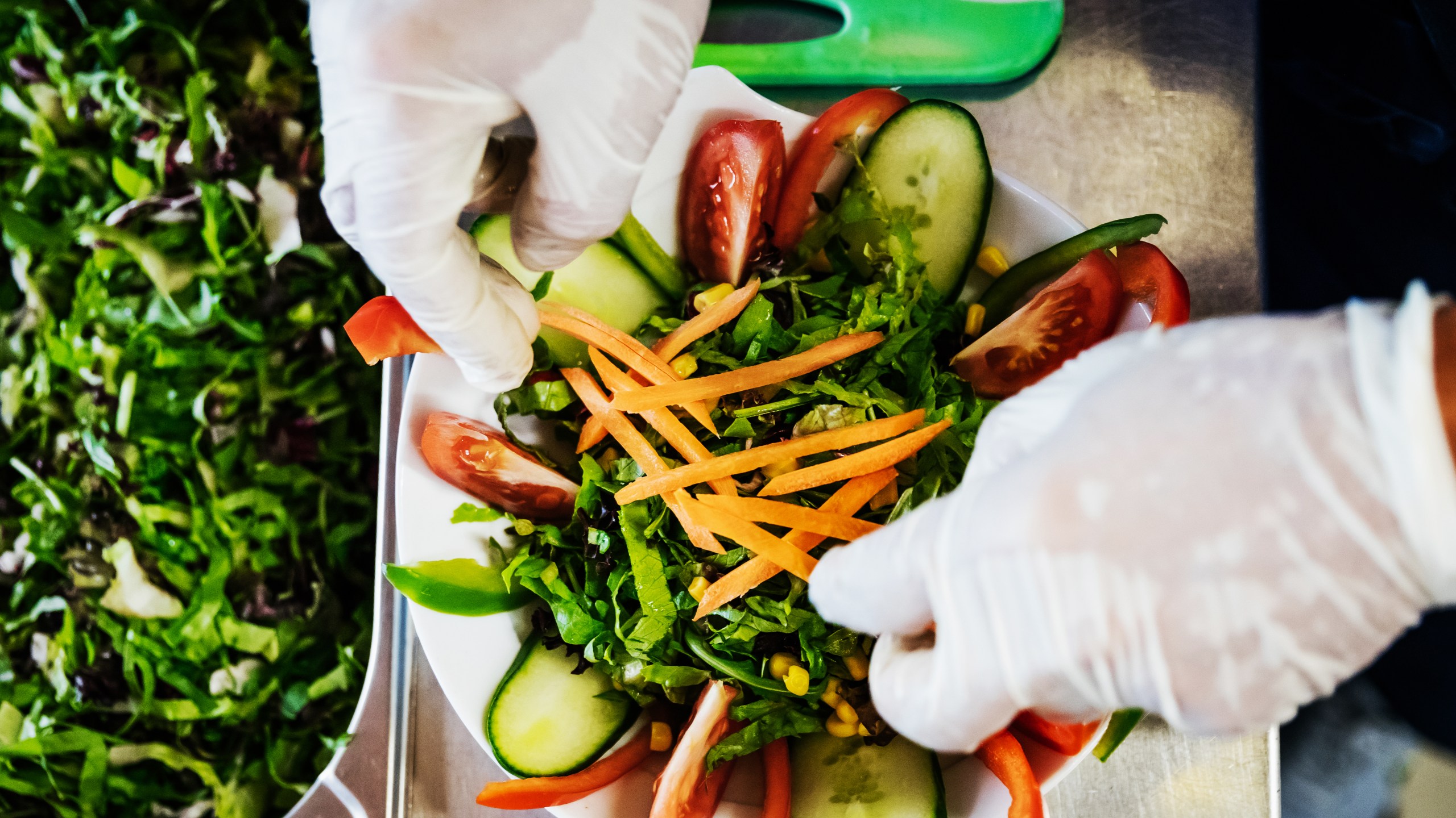 A worker is preparing some salad dishes in this file photo. (Getty Images)