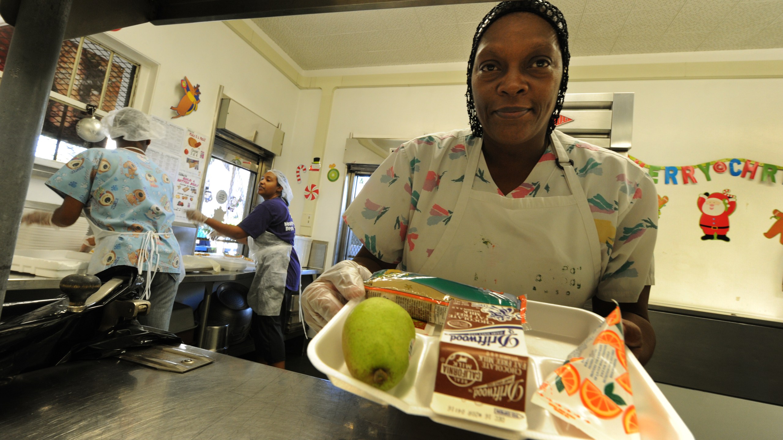 Cafeteria workers prepare lunches for school children at the Normandie Avenue Elementary School in South Central Los Angeles on Dec. 2, 2010. (MARK RALSTON/AFP via Getty Images)