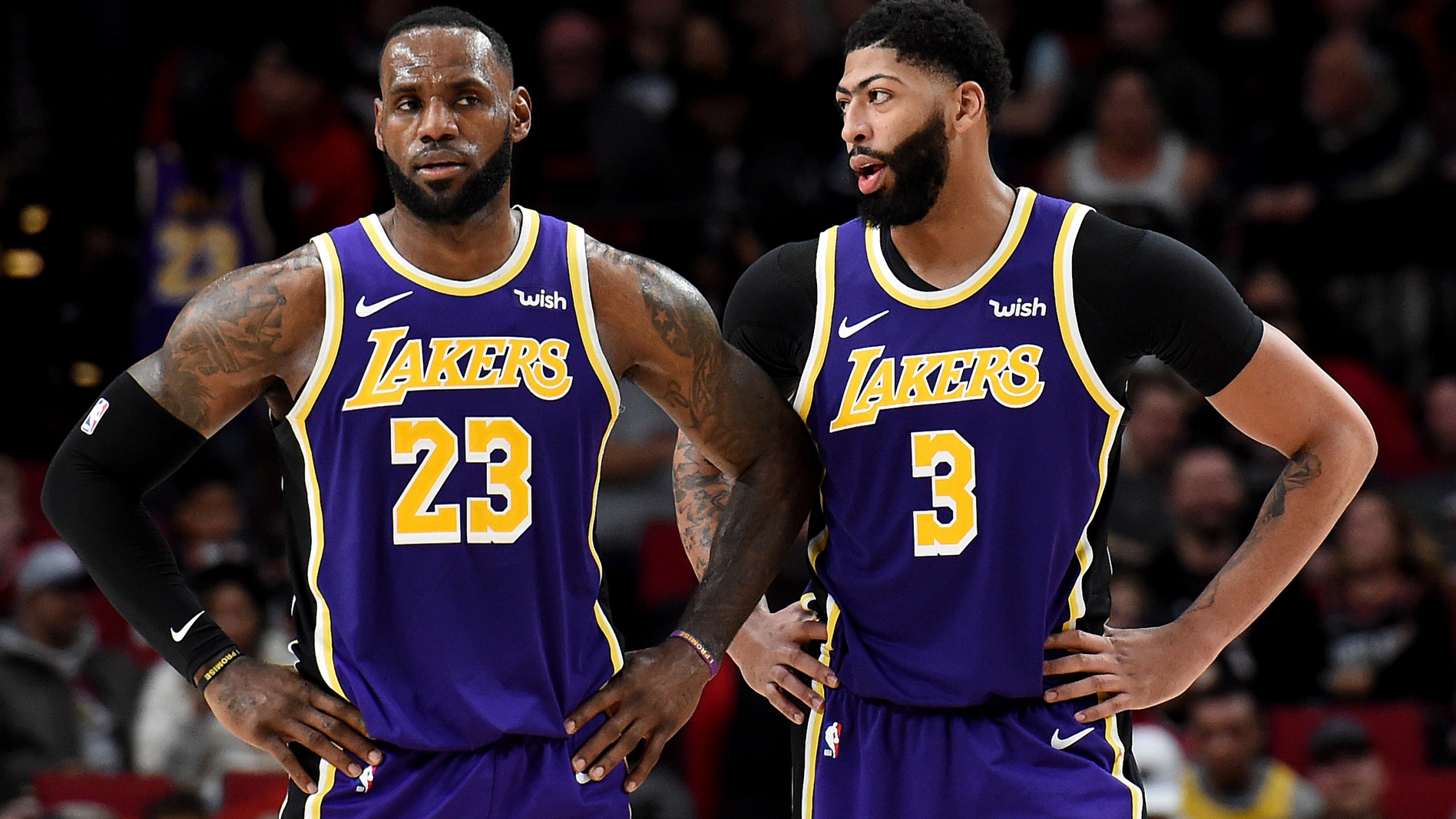 LeBron James and Anthony Davis of the Los Angeles Lakers speak during a time out in the second half of the game against the Portland Trail Blazers at Moda Center on December 06, 2019. (Steve Dykes/Getty Images)