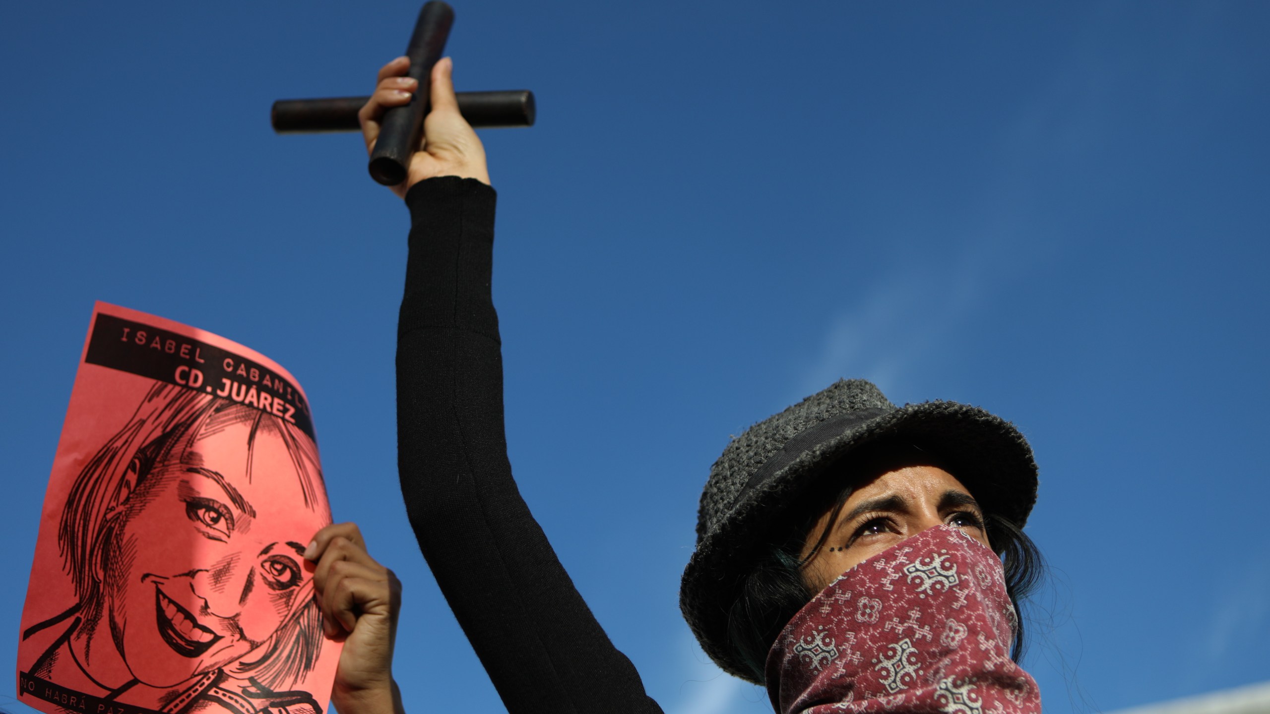 A woman gestures next to an image of slain 26-year-old artist, activist and feminist Isabel Cabanillas de la Torre as she joins demonstrators from Mexico and the U.S. to protest against femicides in Ciudad Juarez and Cabanillas de la Torre's murder, in Ciudad Juarez, in the state of Chihuahua, Mexico, on Jan. 25, 2020. (HERIKA MARTINEZ / AFP)