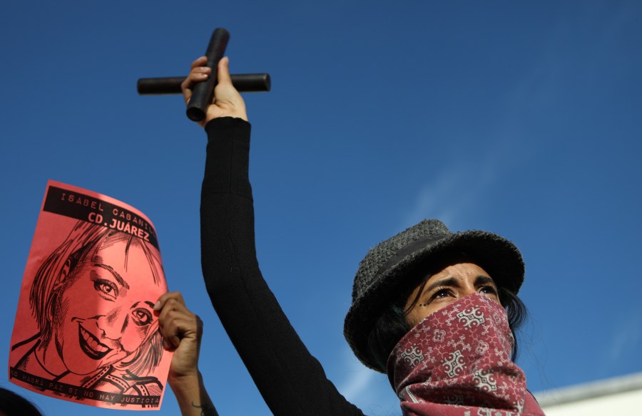 A woman gestures next to an image of slain 26-year-old artist, activist and feminist Isabel Cabanillas de la Torre as she joins demonstrators from Mexico and the U.S. to protest against femicides in Ciudad Juarez and Cabanillas de la Torre's murder, in Ciudad Juarez, in the state of Chihuahua, Mexico, on Jan. 25, 2020. (HERIKA MARTINEZ / AFP)