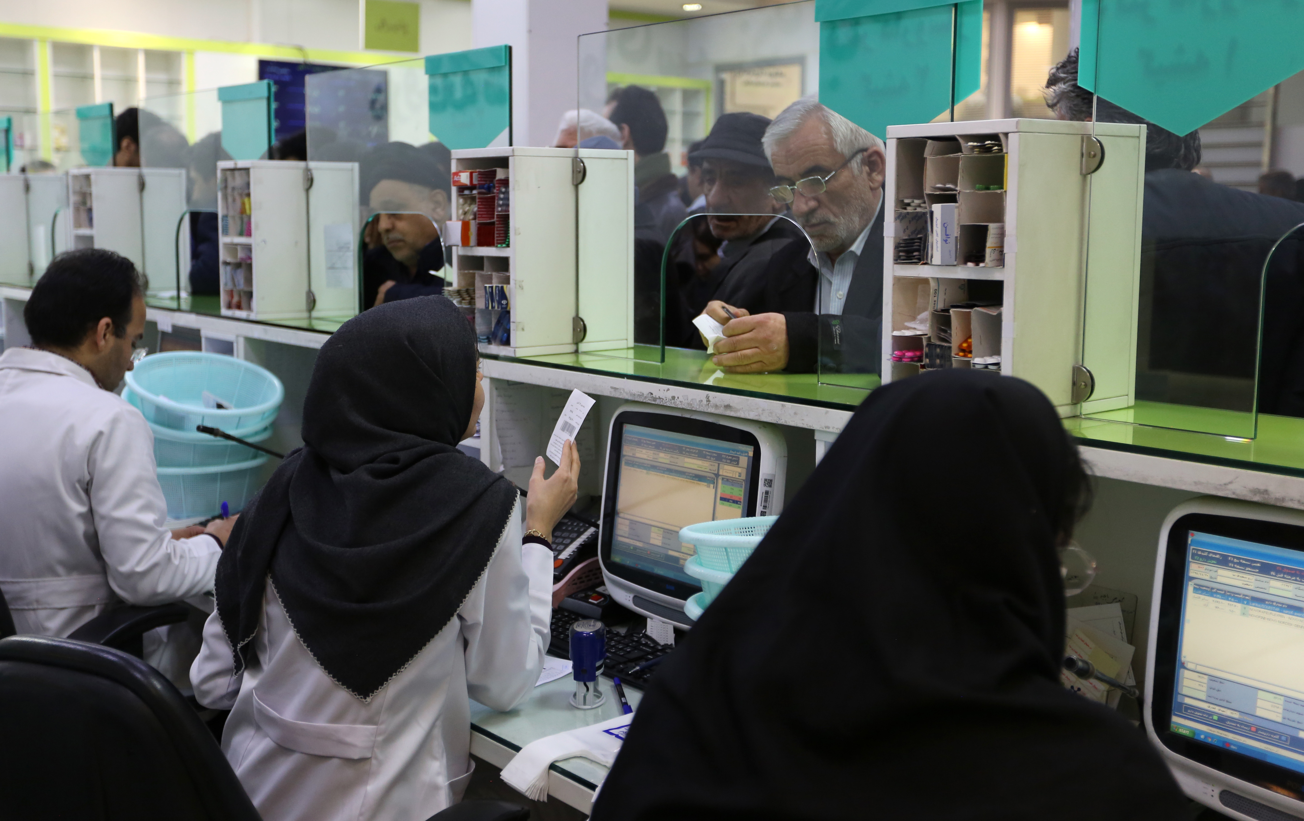 Iranians wait to get prescription drugs at the state-run "13 Aban" pharmacy in Tehran on Feb. 19, 2020. (ATTA KENARE/AFP via Getty Images)