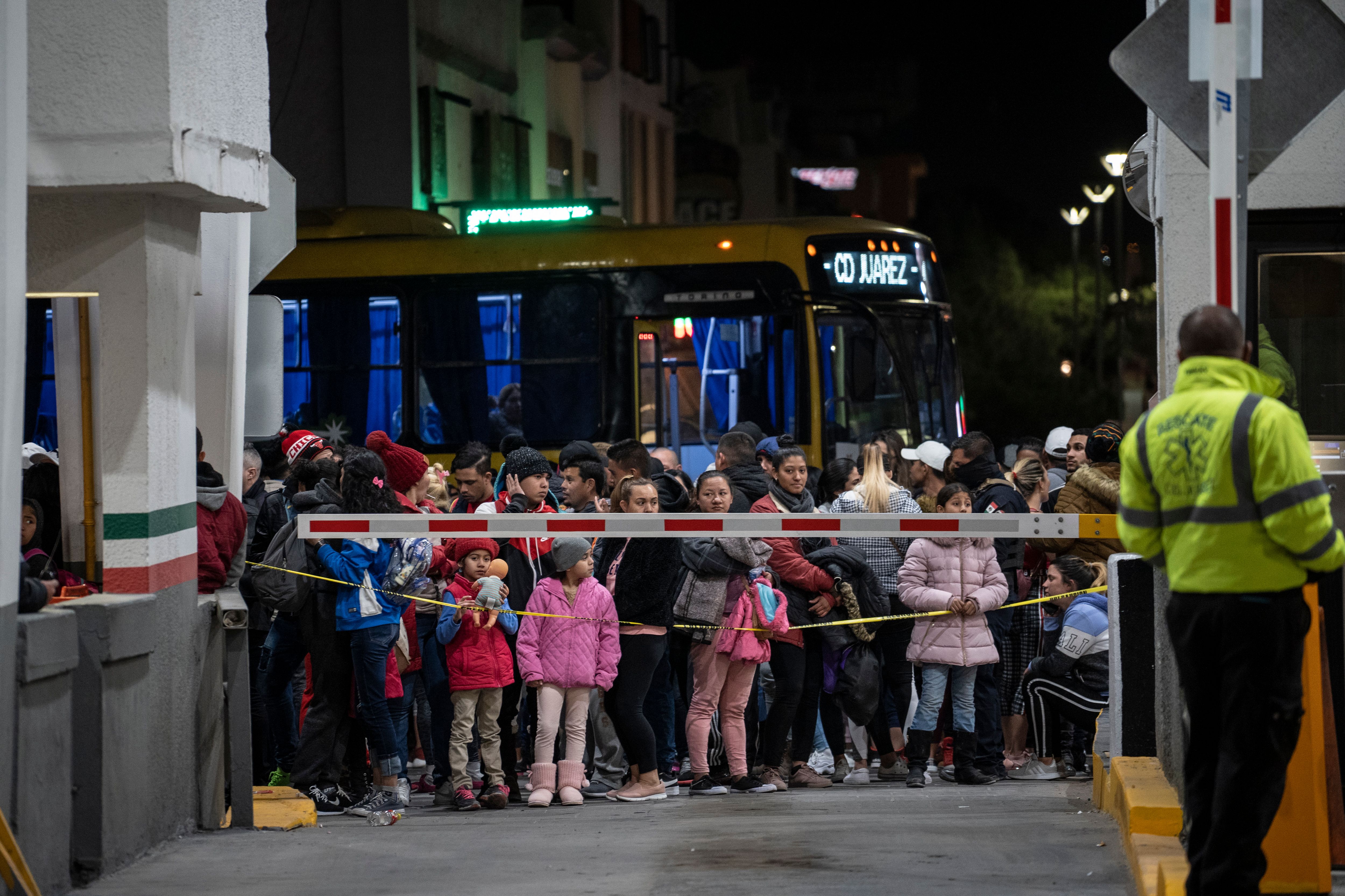 Migrants part of the Remain in Mexico policy wait at the entrance to the Paso del Norte International Bridge on Feb. 28, 2020, in Ciudad Juárez. (Paul Ratje/AFP via Getty Images)