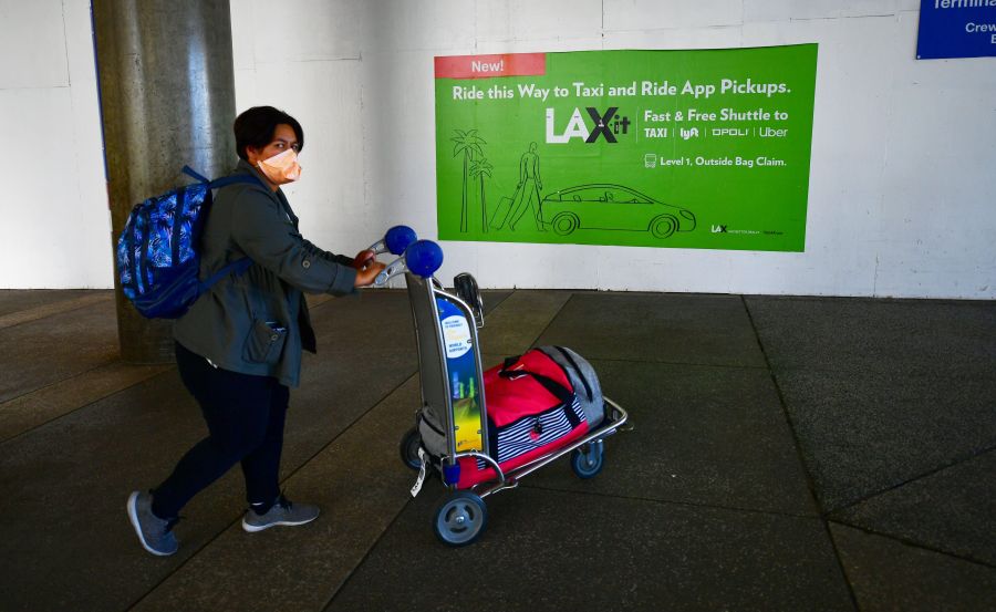 A woman wears a face mask at Los Angeles International Airport on March 2, 2020. (FREDERIC J. BROWN/AFP via Getty Images)